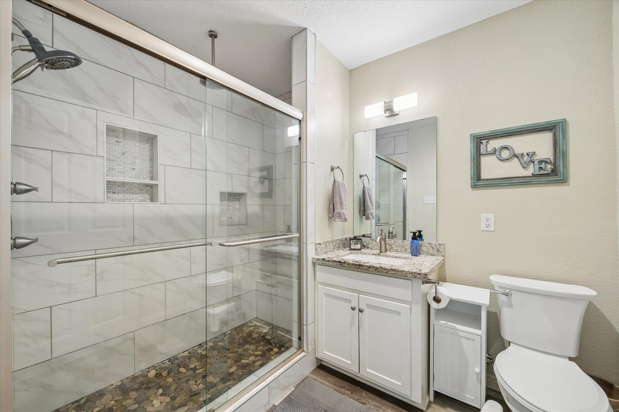 Primary bathroom with a walk-in shower.