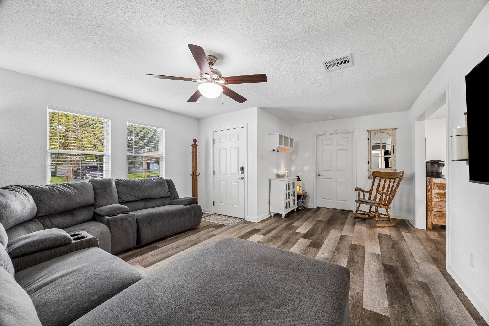 Enter into the front living room.  The windows have been upgraded to Low-E double pane throughout the home.