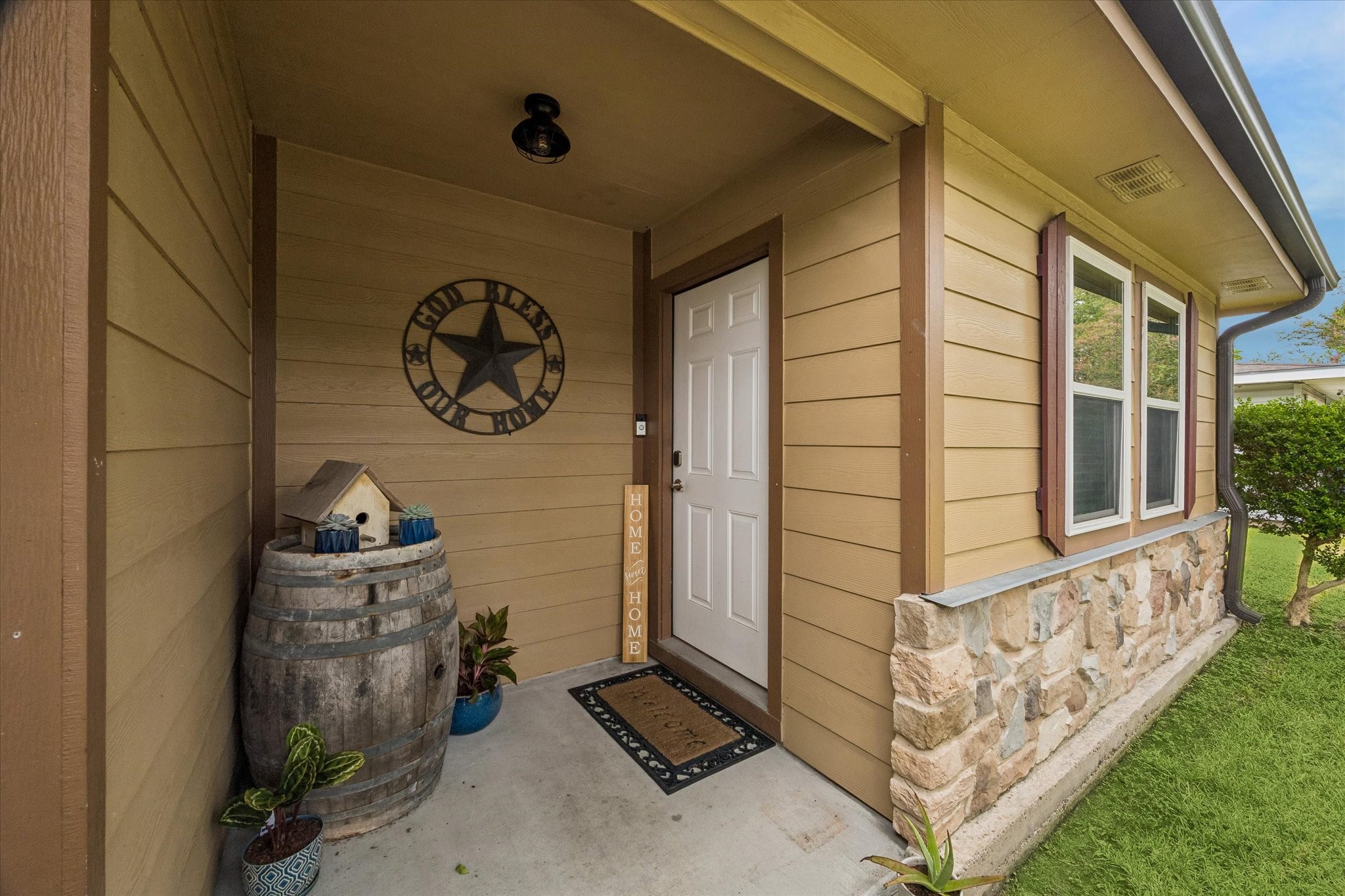 Front door entry which highlights the recently installed hardie plank and stone work.