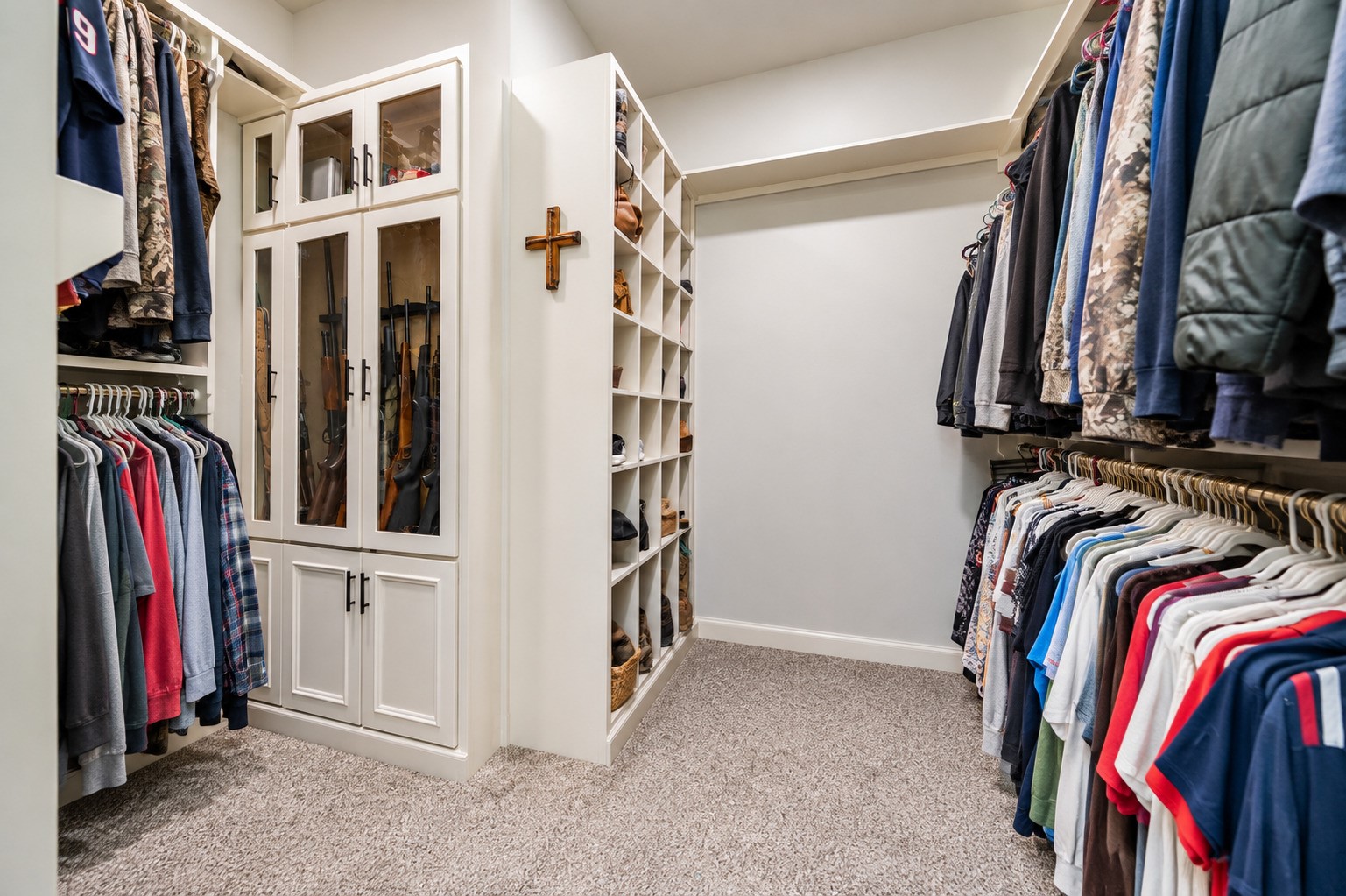 Large primary walk-in closet with built-in shelving and hanging space. This photo may be edited using AI tools.
