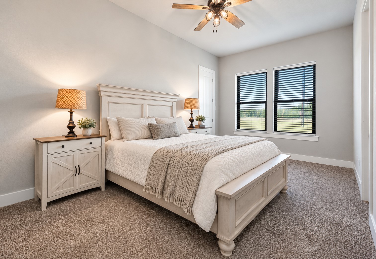 Secondary bedroom with carpet, ceiling fan and two windows for natural light. This photo may be edited using AI tools.