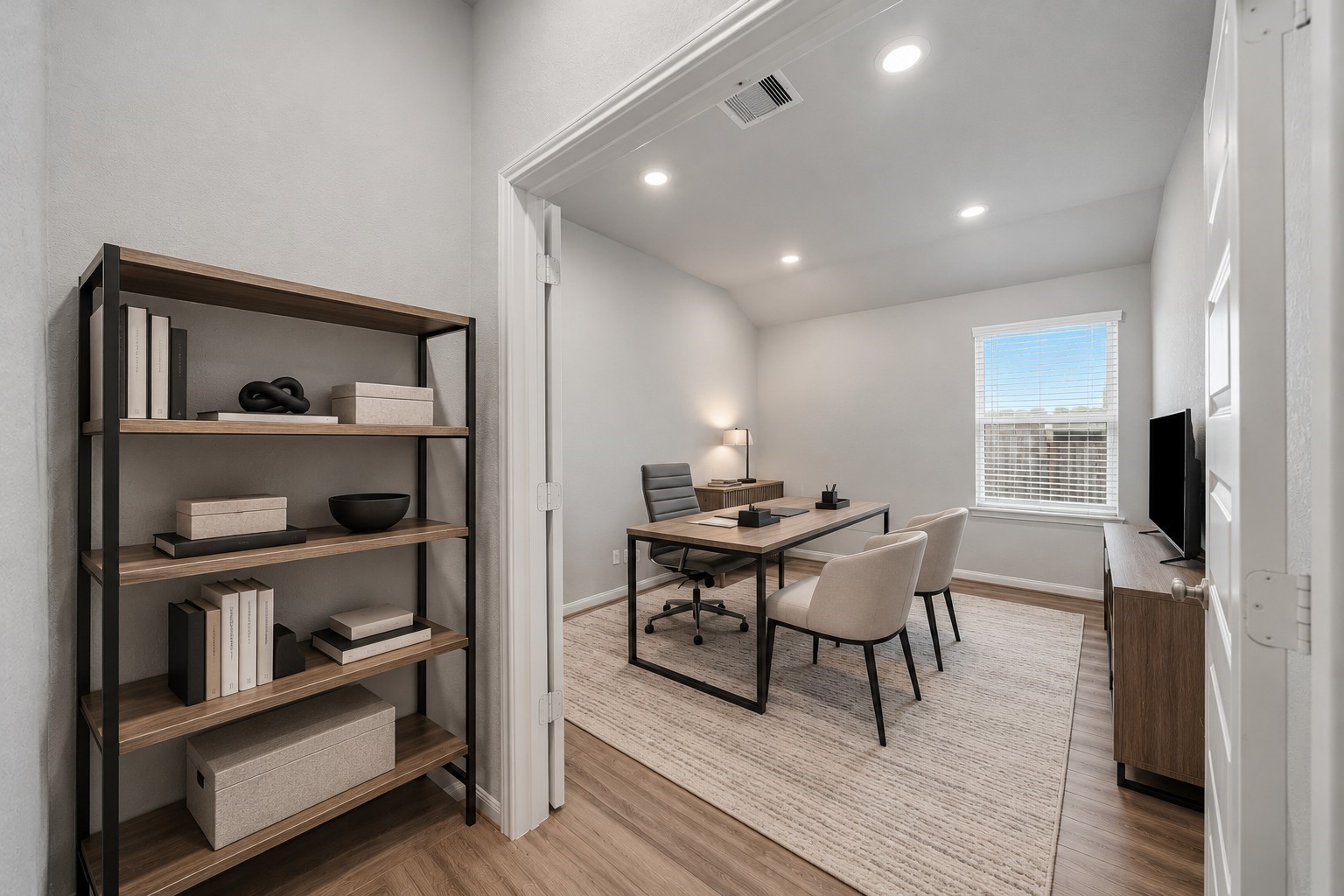 Virtually Staged: This inviting home office features a spacious layout with high ceilings, and an attractive flooring that creates a clean, modern atmosphere. The room's versatile floor plan offers ample space for a comfortable and productive workspace, with a wide entryway and convenient access to the adjoining area.