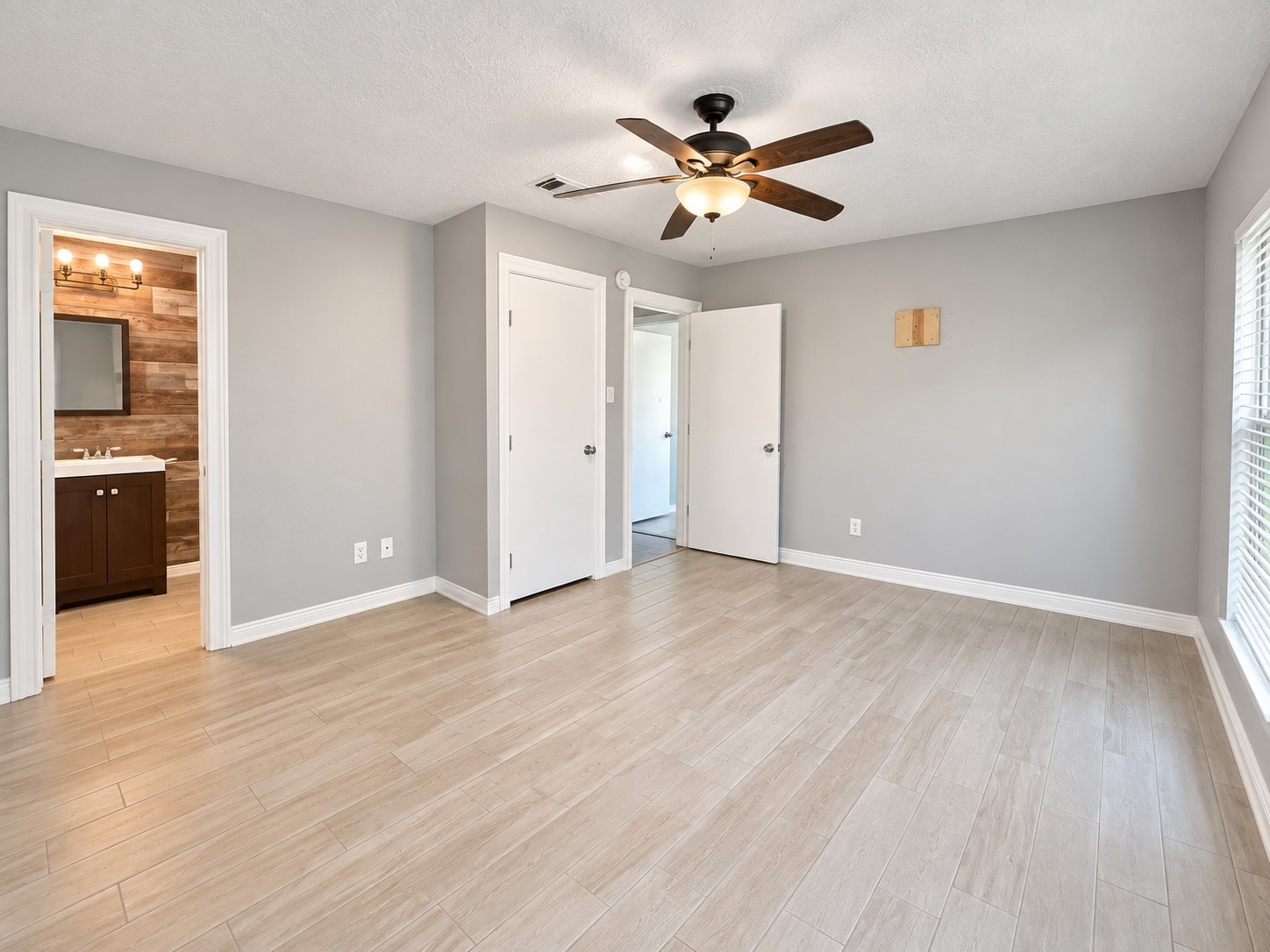 Master bedroom with wood look tile flooring