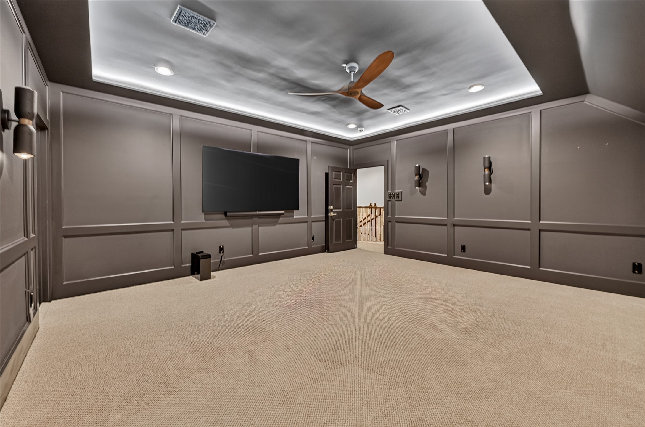 There is a hidden media room tucked away to side of playroom for a more intimate gathering.