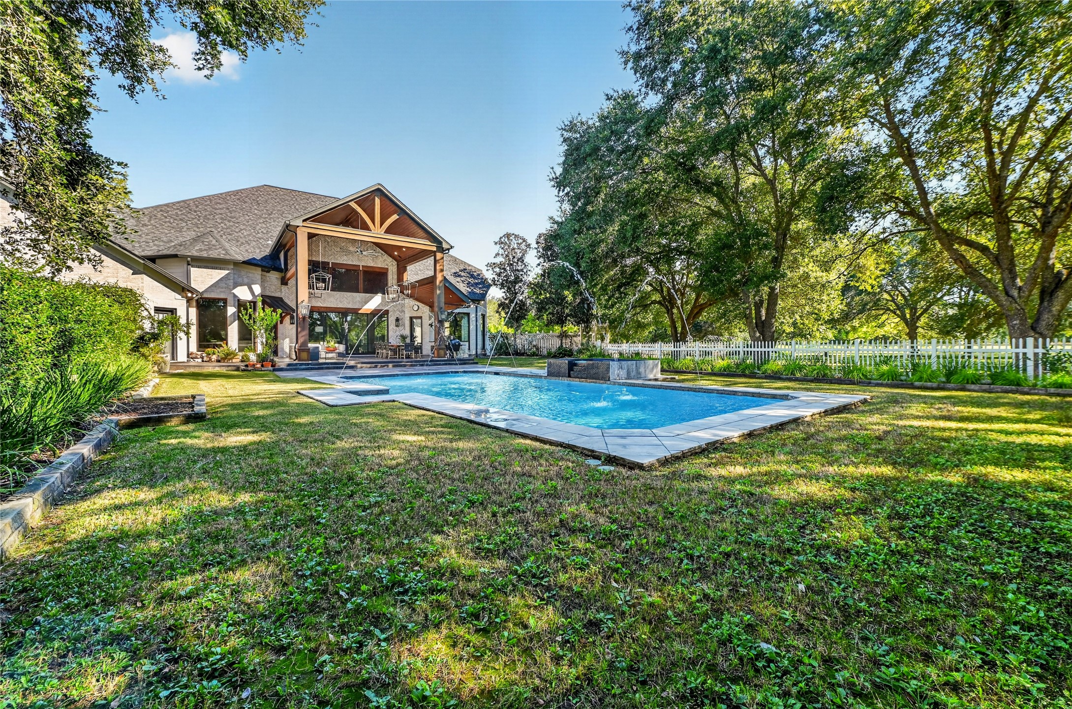 The exterior of the home is surrounded by lush landscaping and an abundance of trees. No neighbors on any side makes this the ultimate private retreat.