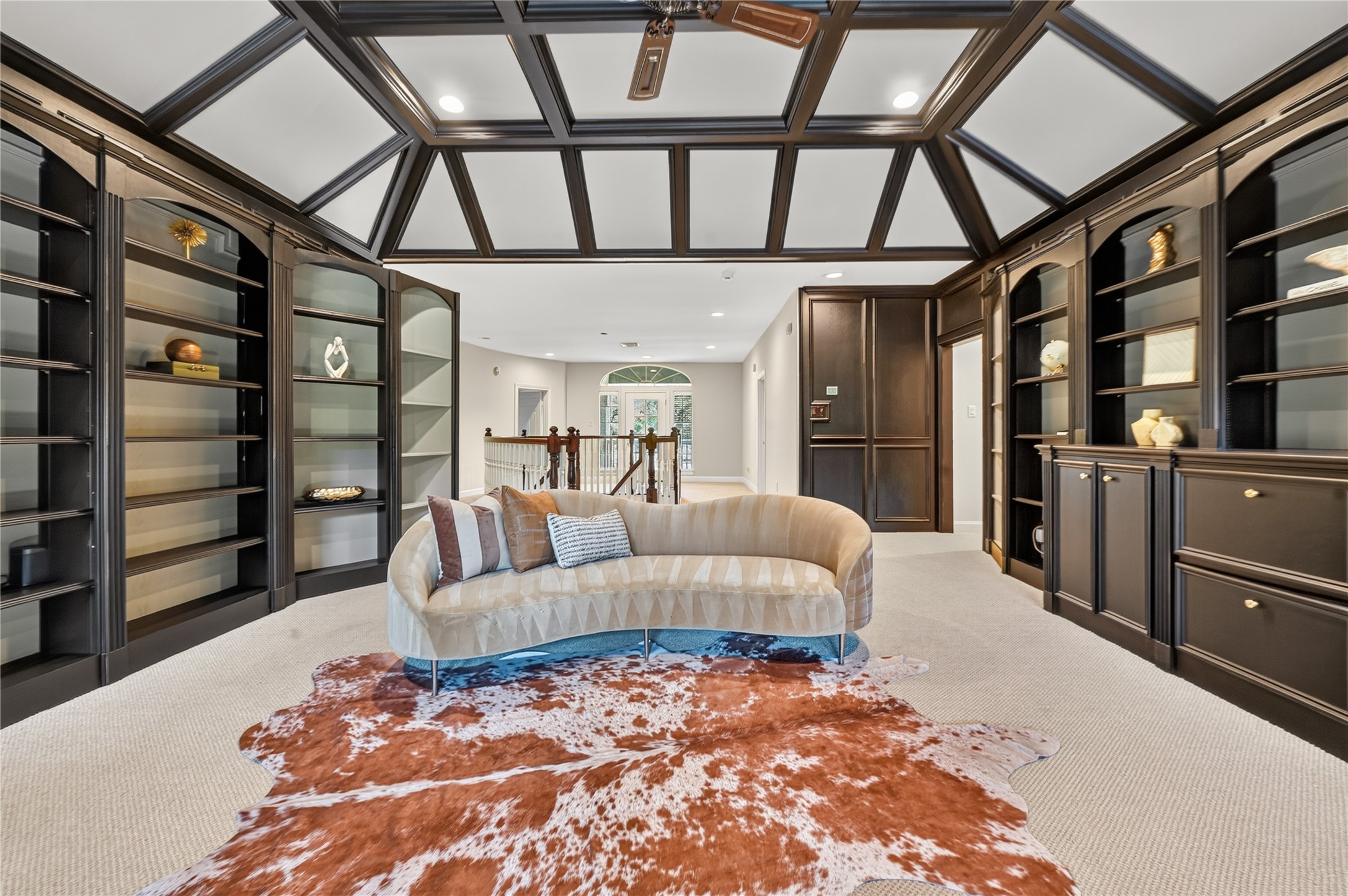 Media rooms and bedrooms are flanked on both sides of playroom. 2 staircases lead to front and side entry of home.