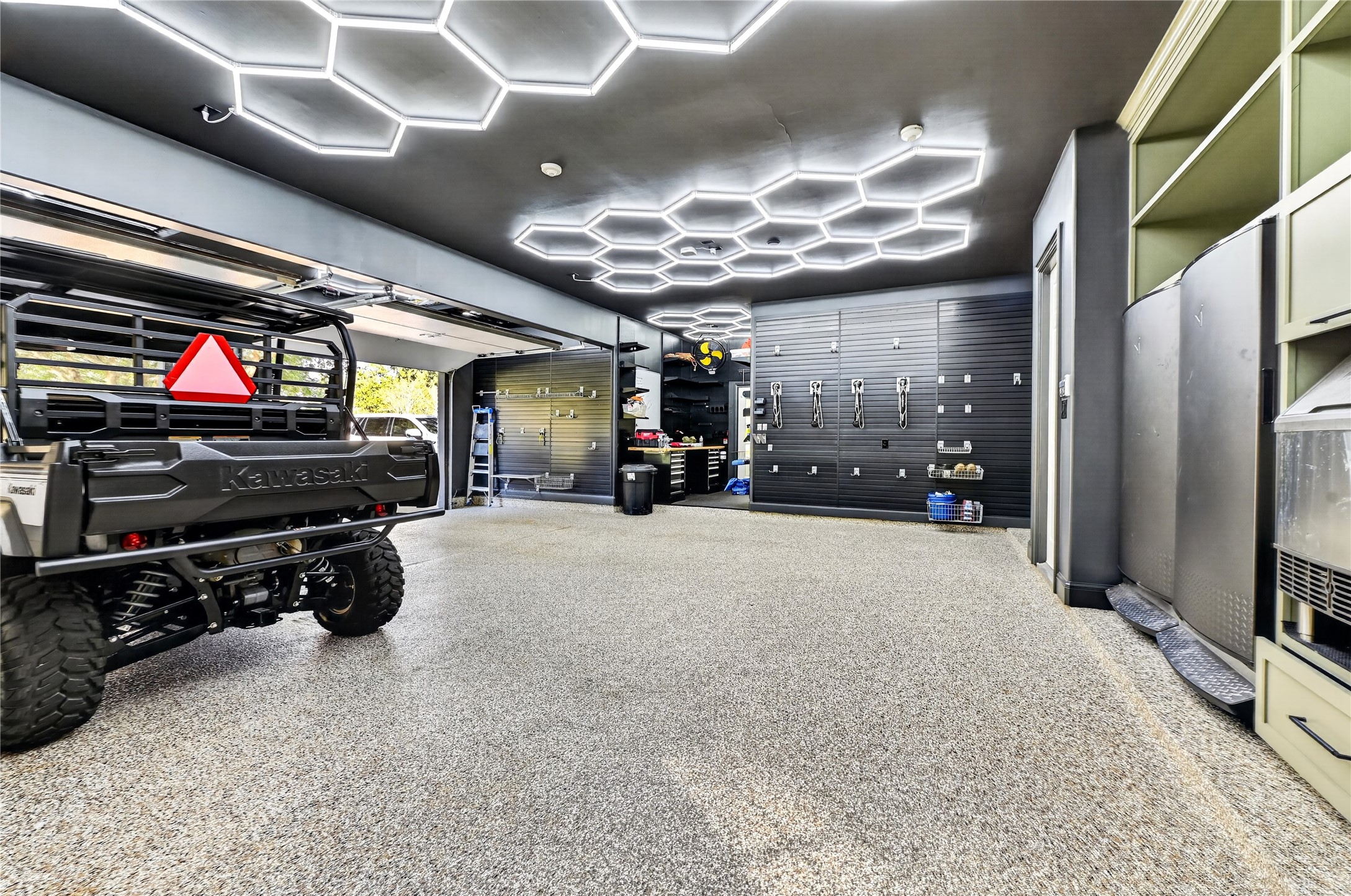 Garage recently upgraded with extensive organization and lift systems for storage.