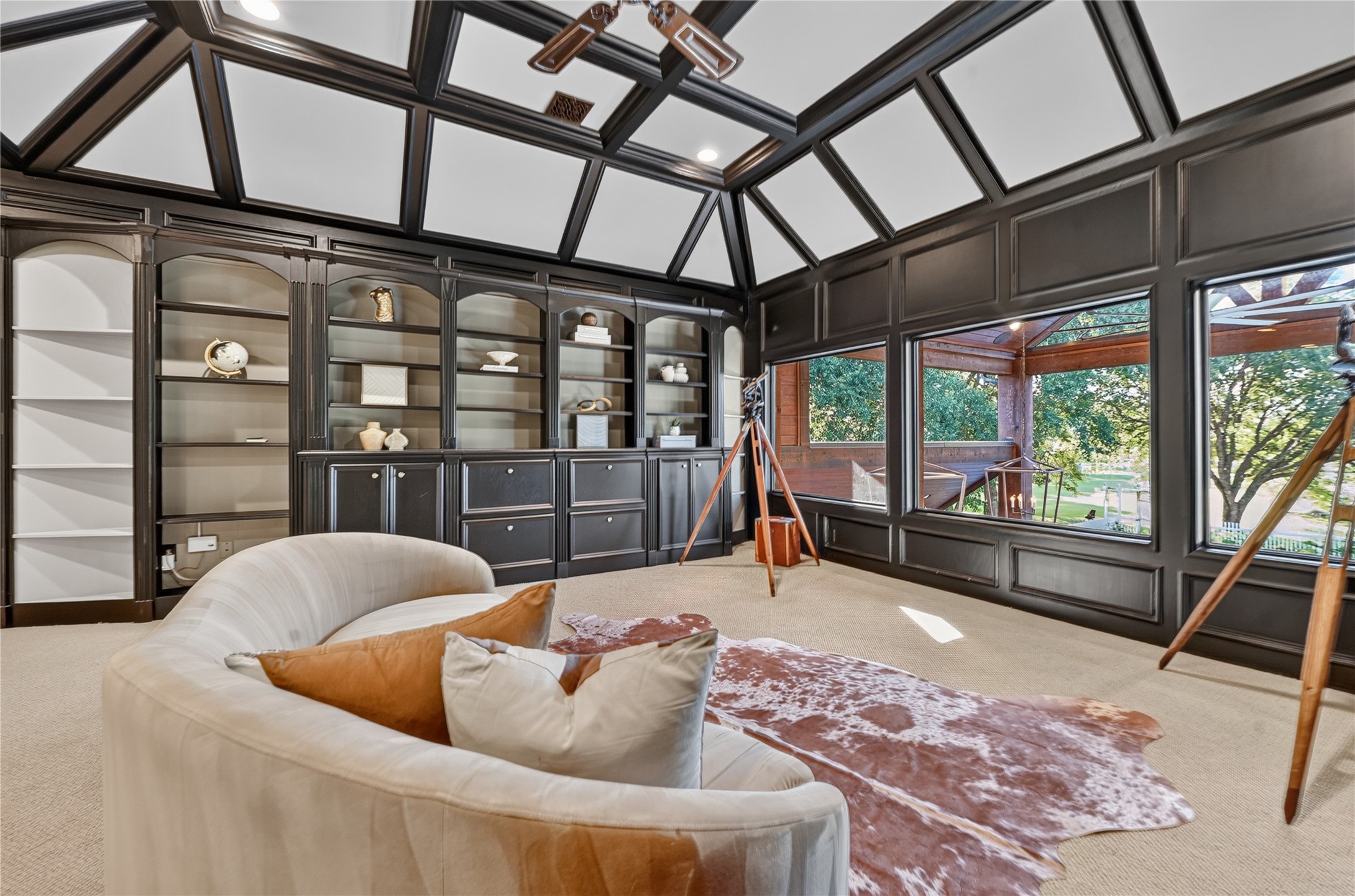 Fresh design complete with built-ins and a view of the backyard oasis from upstairs are the perfect compliment this playroom or secondary office.