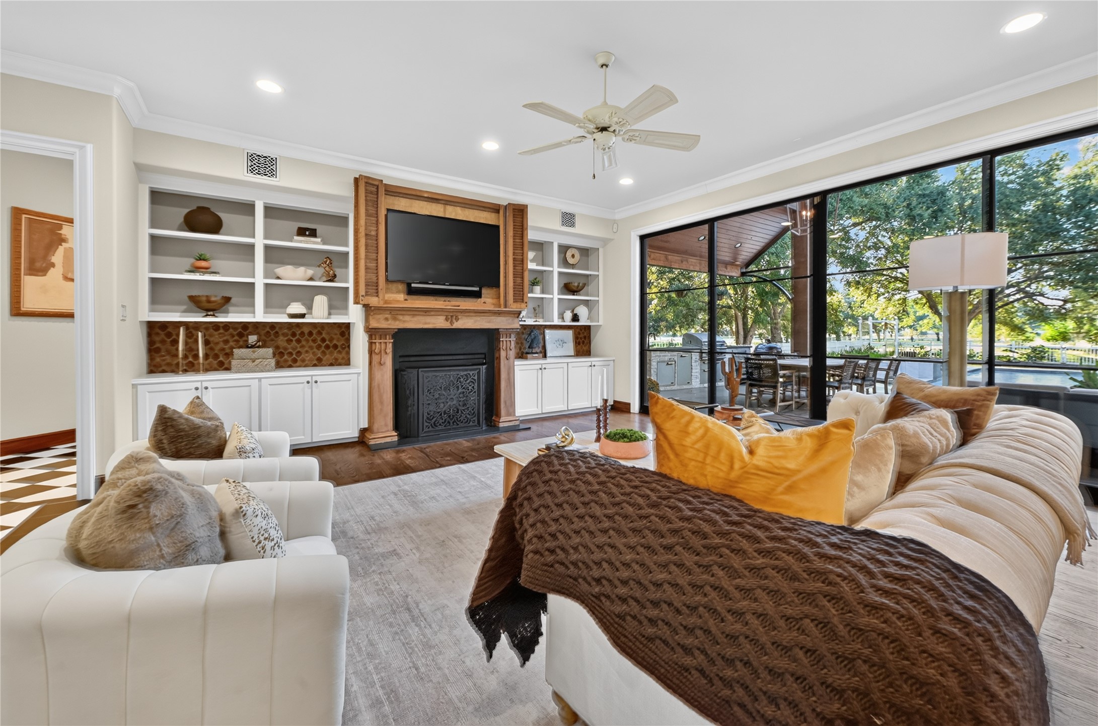 Cozy living opens to expansive views of the the backyard, complete with industrial sliding doors and surround sound for entertaining.