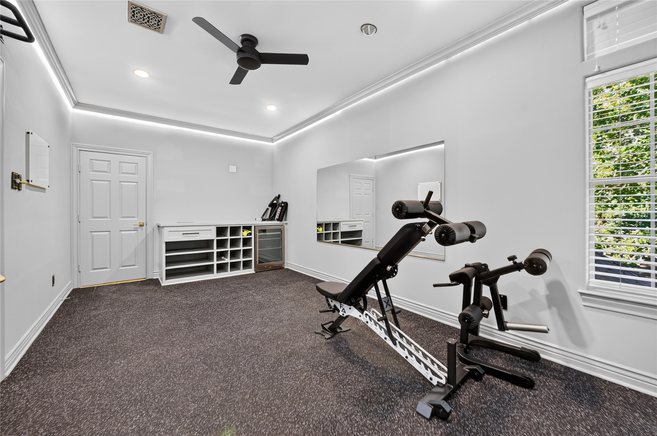 The gym is located upstairs past the media room.