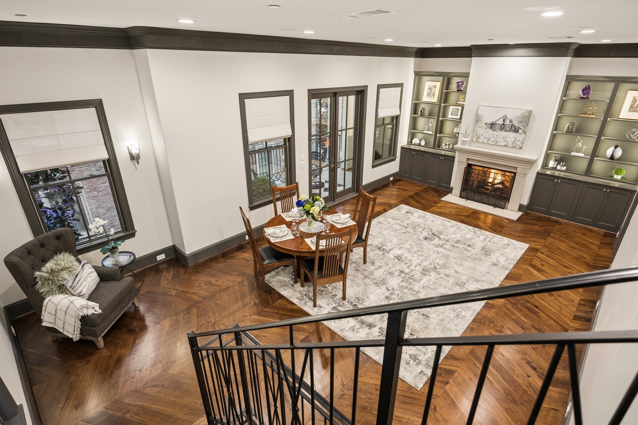 Elegant formal living room with a fireplace, custom built-ins, and generous space for a dining area if desired. French doors open to a spacious private outdoor patio, perfect for relaxing and entertaining.
