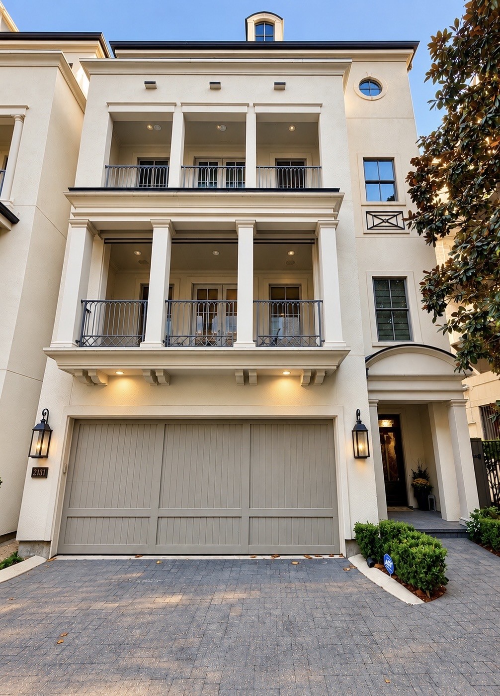 Daylight view of this elegant luxury residence, showcasing timeless architecture, impressive balconies, and a private two-car garage within exclusive gated Bancroft Place.