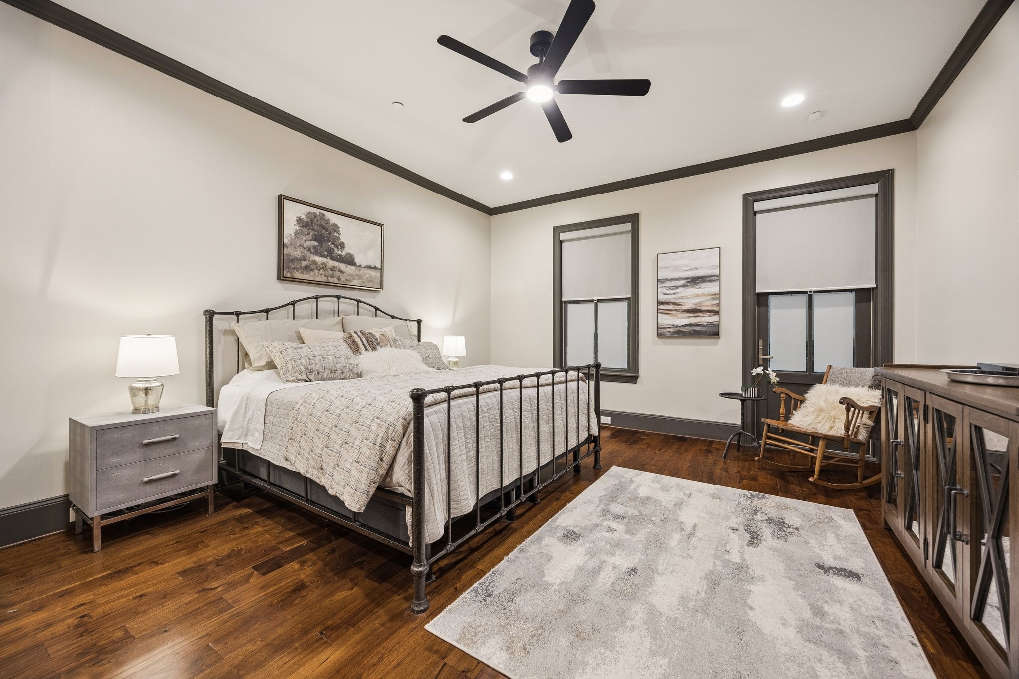Spacious first-floor bedroom featuring beautiful hardwood floors, an en-suite full bathroom, and backyard access. Connects to a versatile additional room, ideal for a private study, lounge, or gym, creating a secluded first-floor suite with exceptional flexibility and privacy.