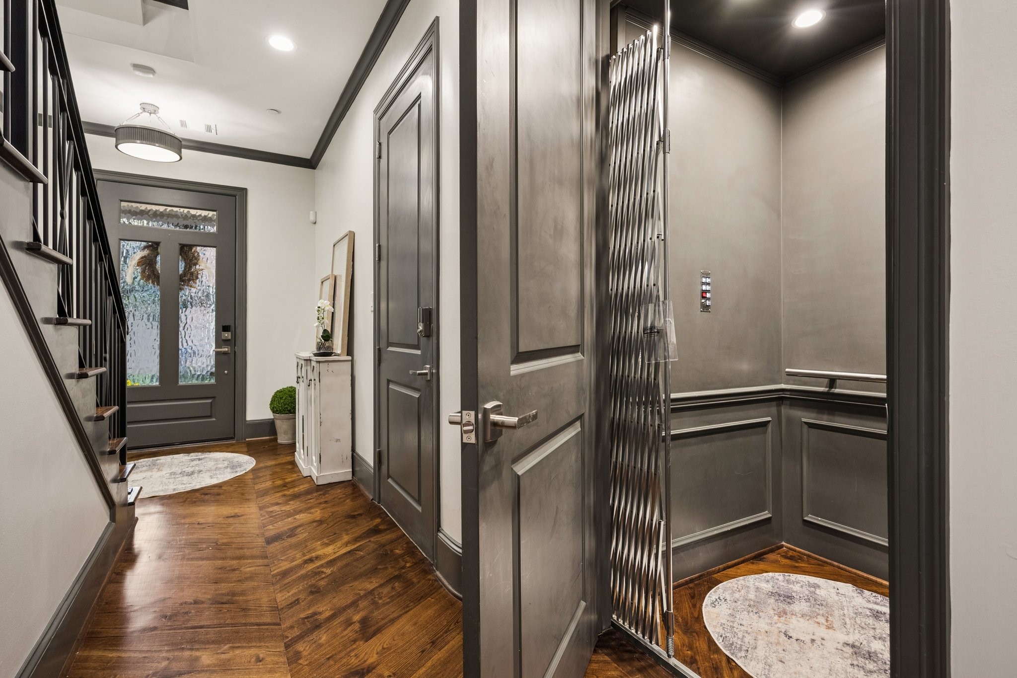 Elegant first-floor foyer featuring rich hardwood floors, custom millwork, and a private elevator providing effortless access to all four levels. Elegant first-floor foyer featuring rich hardwood floors, custom millwork, and a private elevator providing effortless access to all four levels.