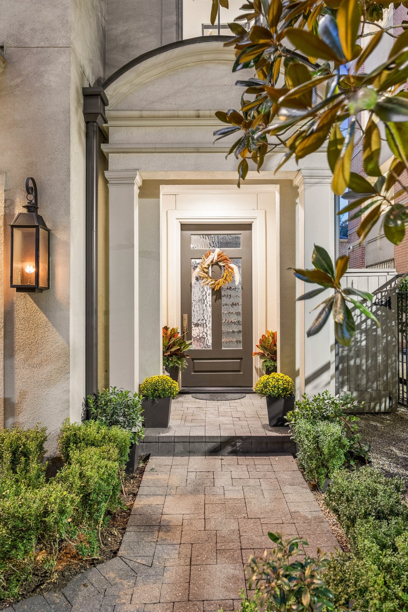 Elegant private entrance framed by lush landscaping, classic architectural details, and a welcoming covered entrywayan inviting introduction to this exceptional residence. Elegant private entrance framed by lush landscaping, classic architectural details, and a welcoming covered entrywayan inviting introduction to this exceptional residence.