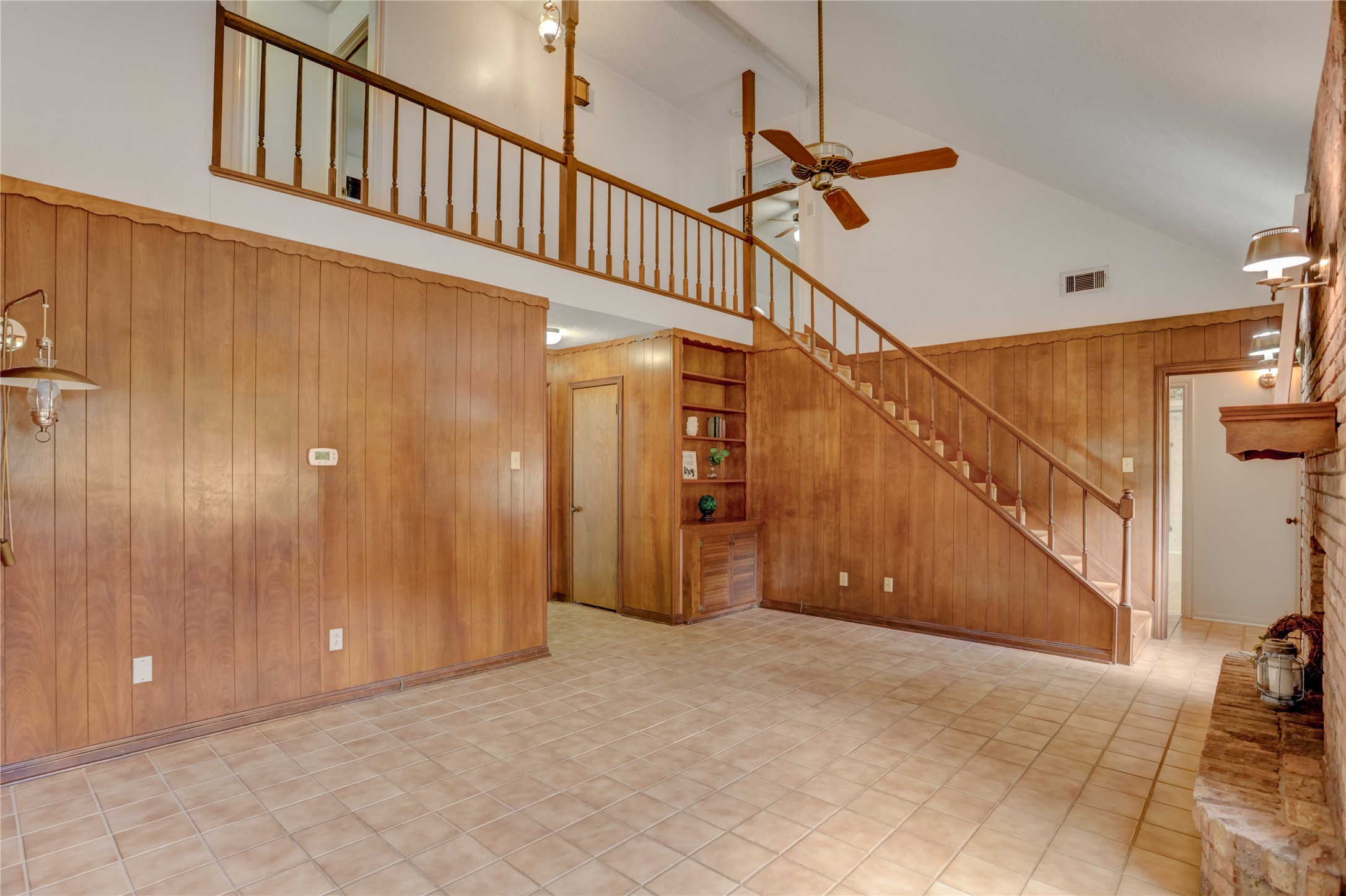 Den and stairs leading to 3 bedrooms and full bath