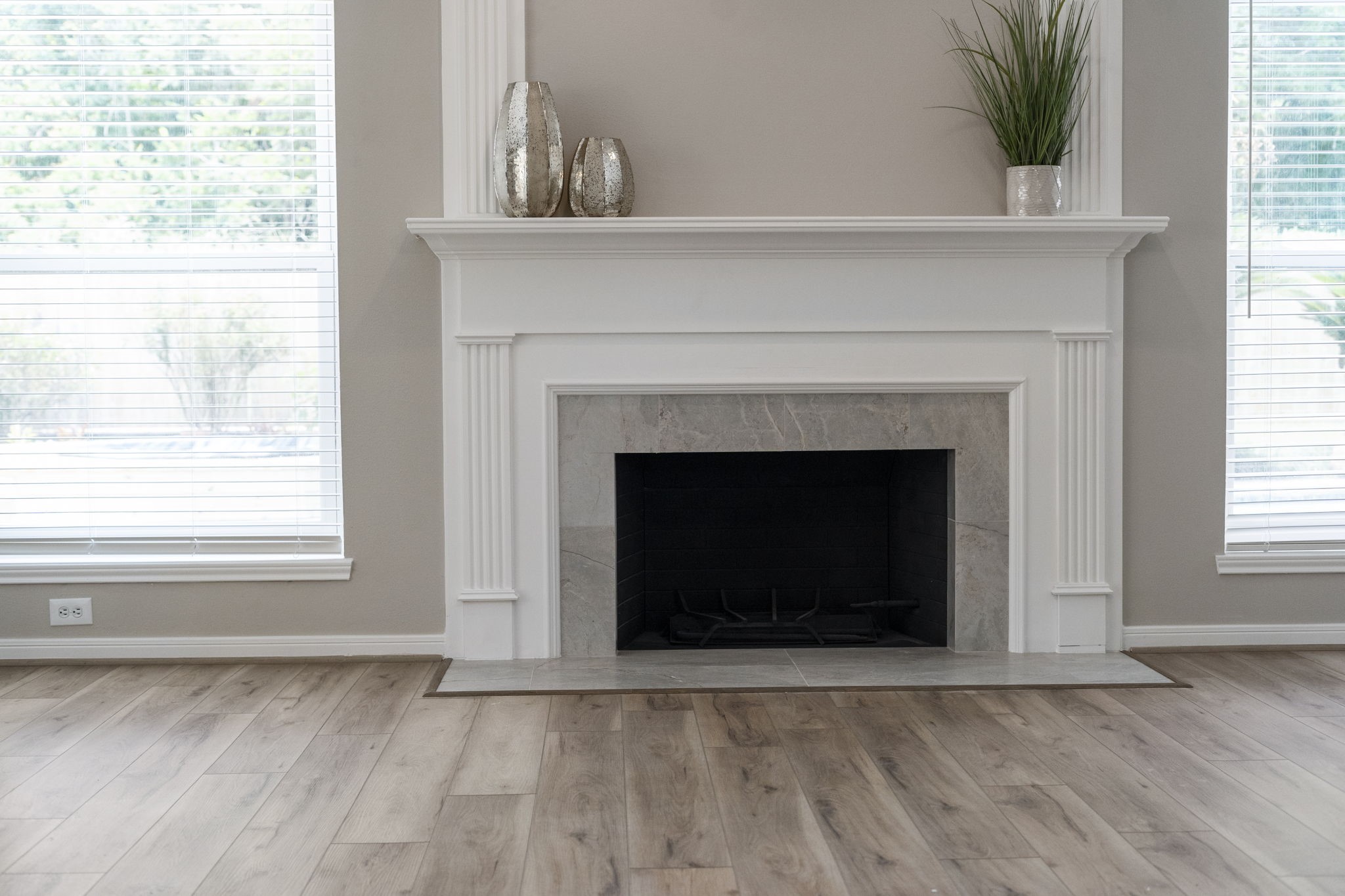 The spacious family room centers around a beautifully remodeled fireplace, framed by windows overlooking the backyard.
