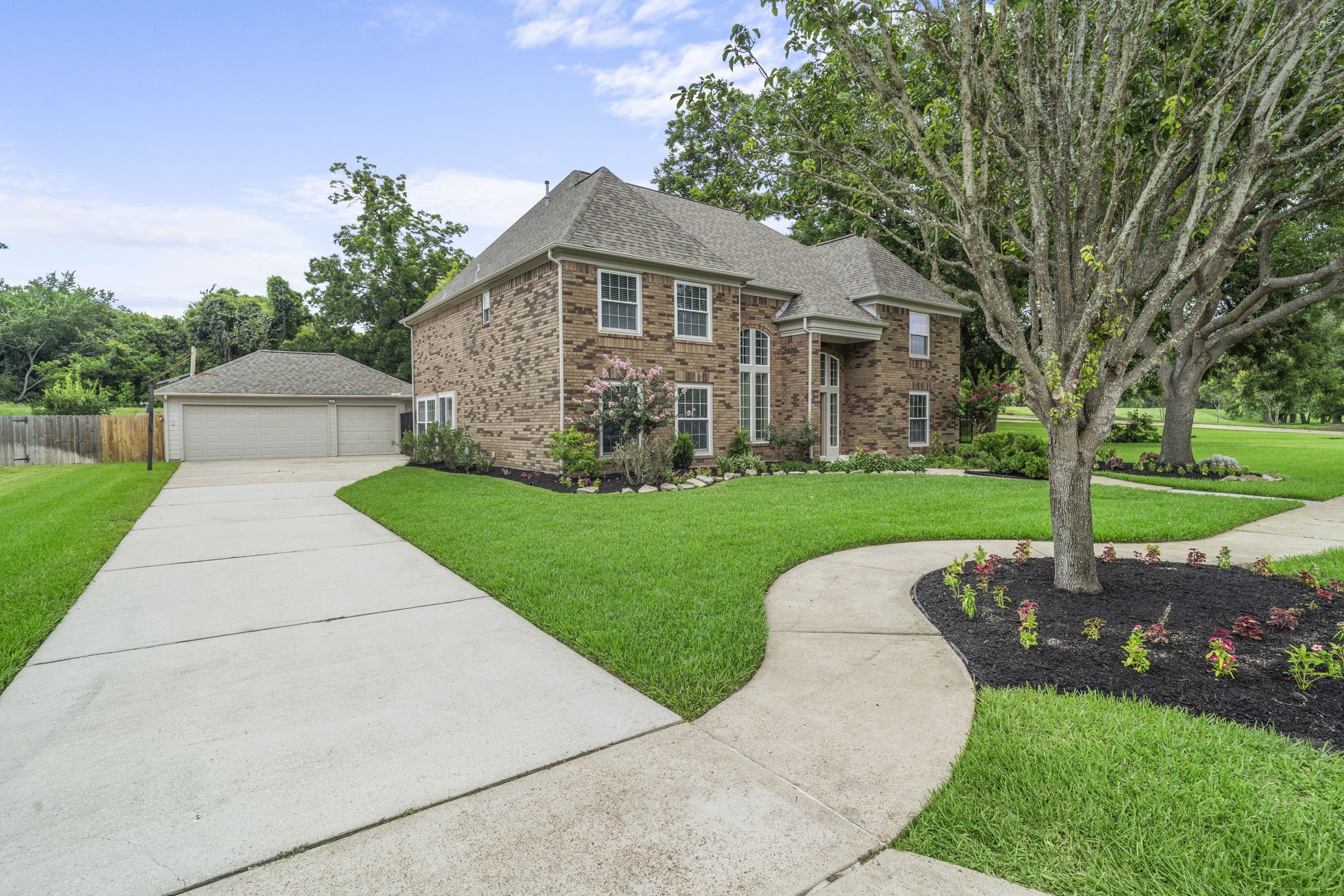 A long driveway leading to the detached 3-car garage for ample parking.