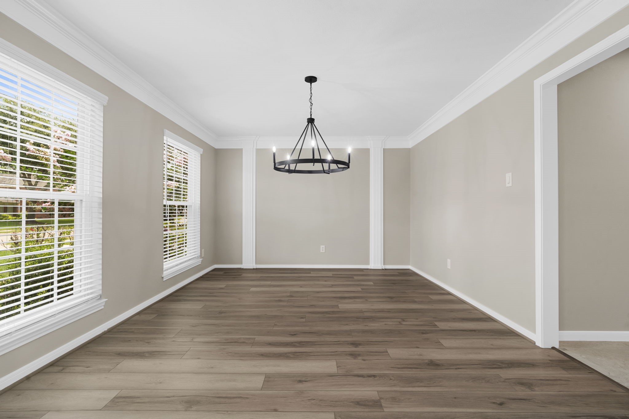 The formal dining room is framed by elegant millwork & abundant natural light. The spacious layout easily accommodates both intimate dinners & larger gatherings.