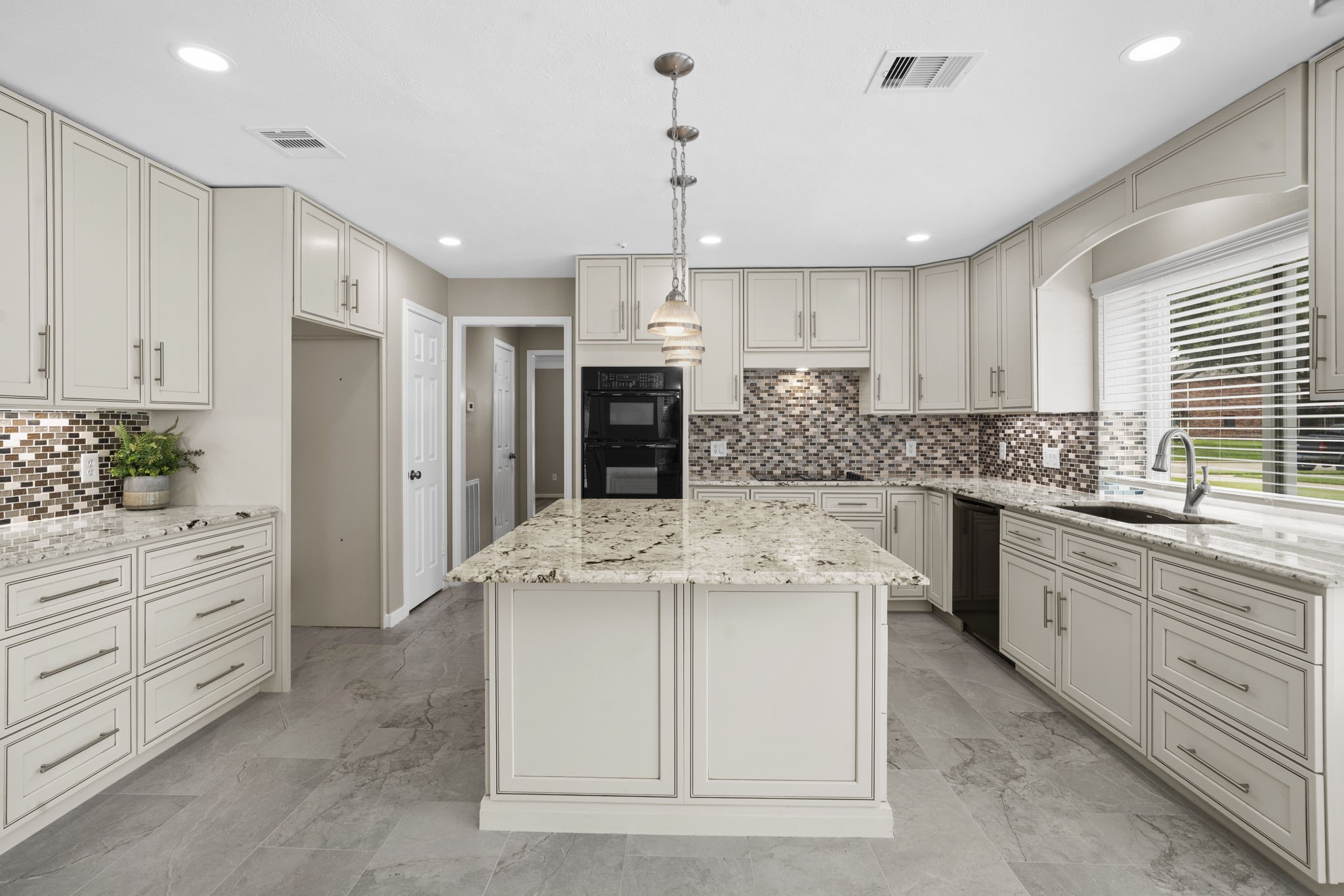 The spacious kitchen is designed with exceptional storage, expansive prep space & a large center island that anchors the room.