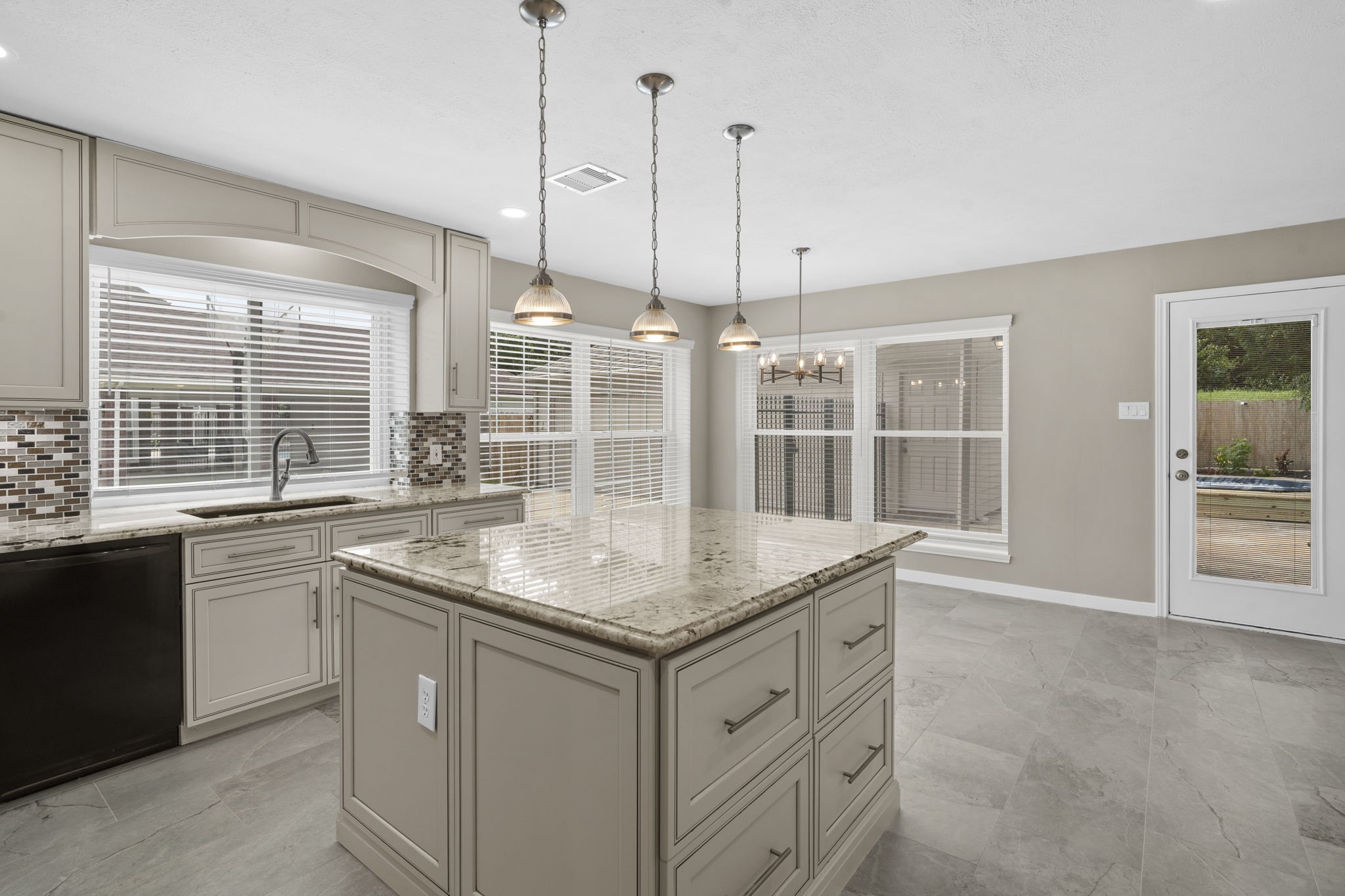 A deep undermount sink paired with a pull-down faucet offers everyday functionality.