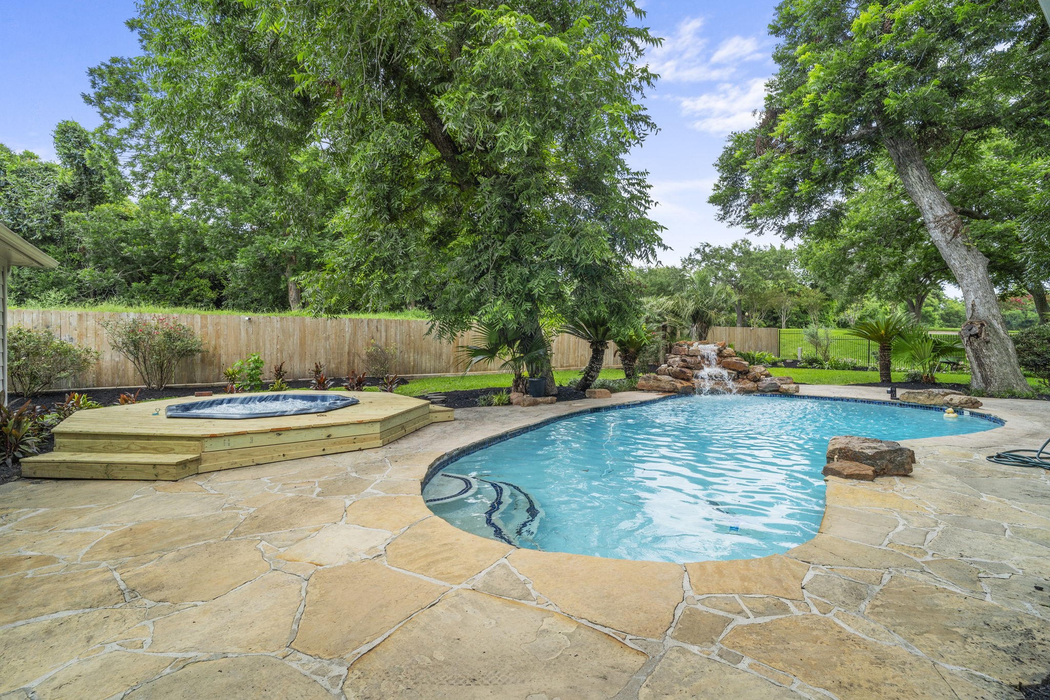 A rebuilt & refinished hot tub deck complements the expansive pool area.