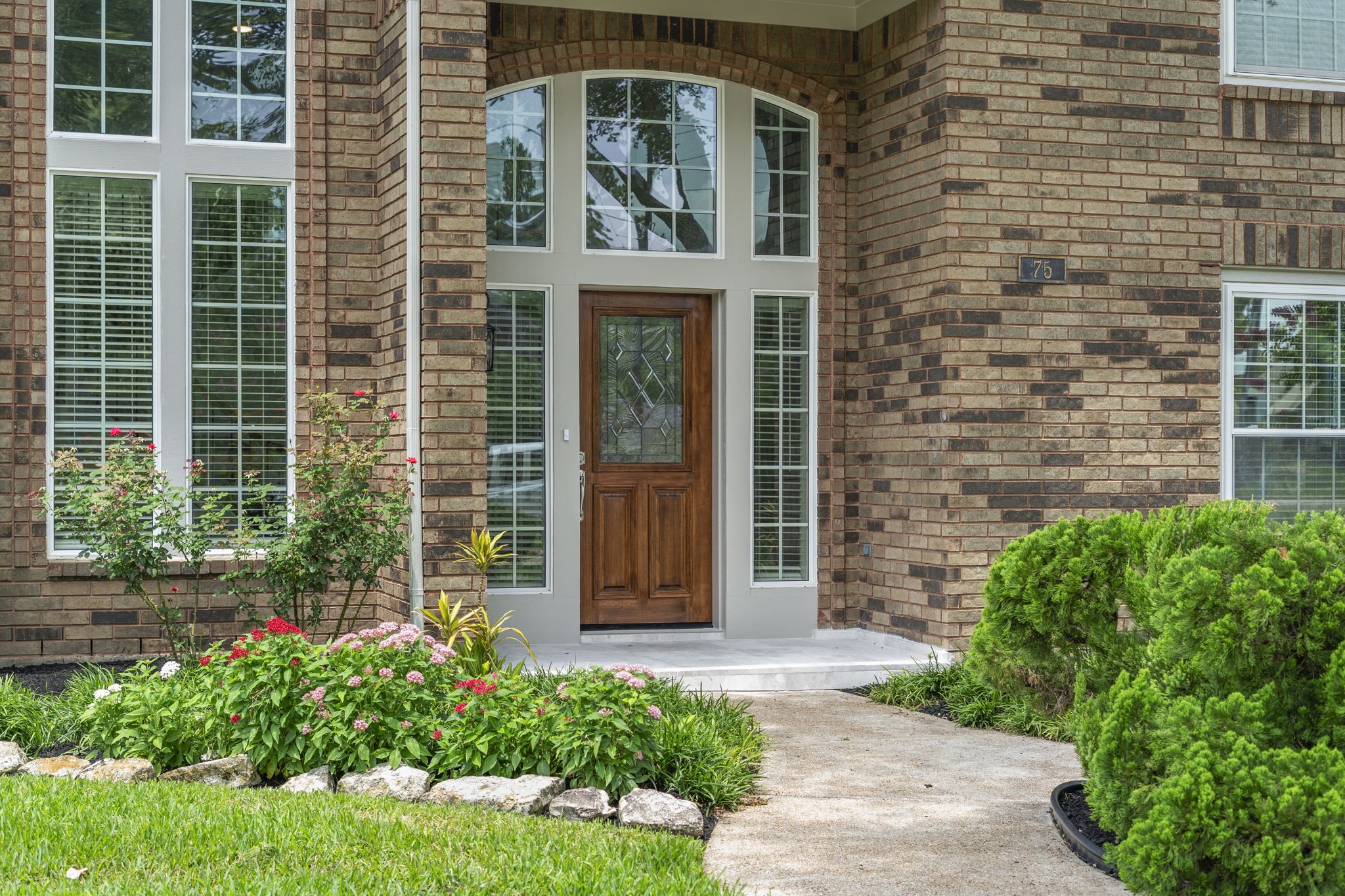 The refreshed front entry welcomes you with a new solid wood door & hardware, framed by dramatic two-story windows that fill the foyer with natural light.