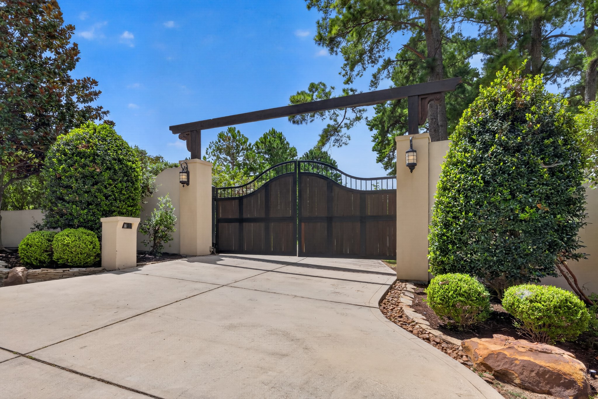 A custom 20-foot oak-and-steel privacy gate creates an entrance as exceptional as the estate beyond.
