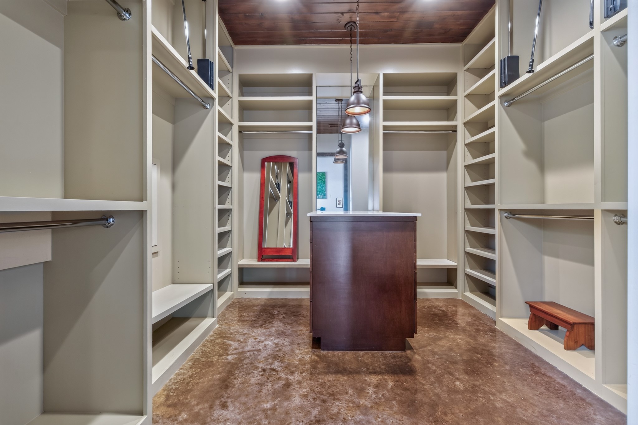 The boutique-style closet pairs abundant organization with the luxury of a central island.