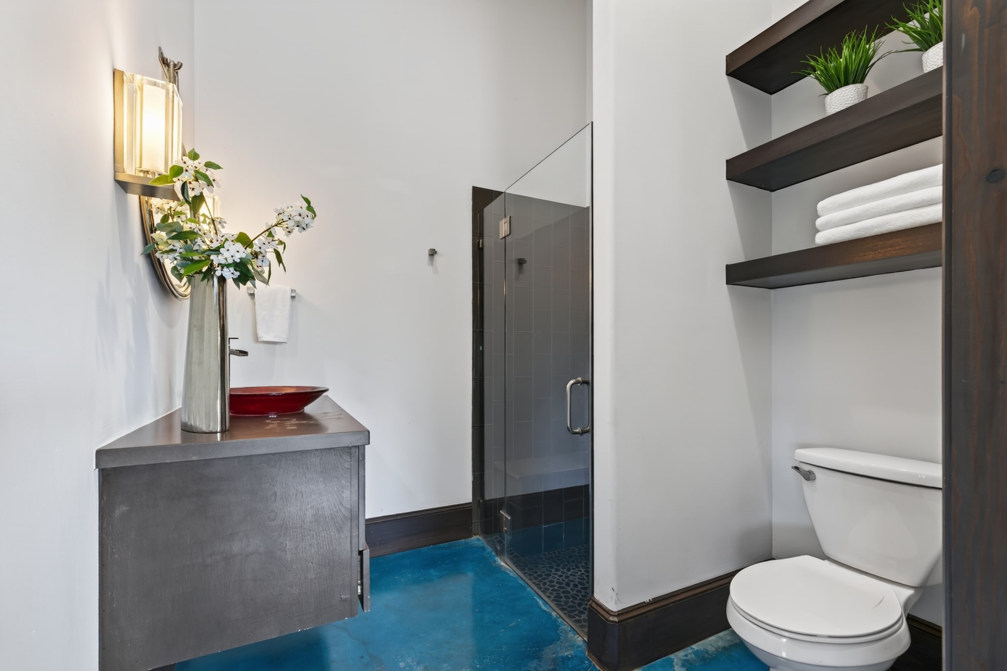 A walk-in shower and thoughtful storage complete this comfortable private guest retreat.