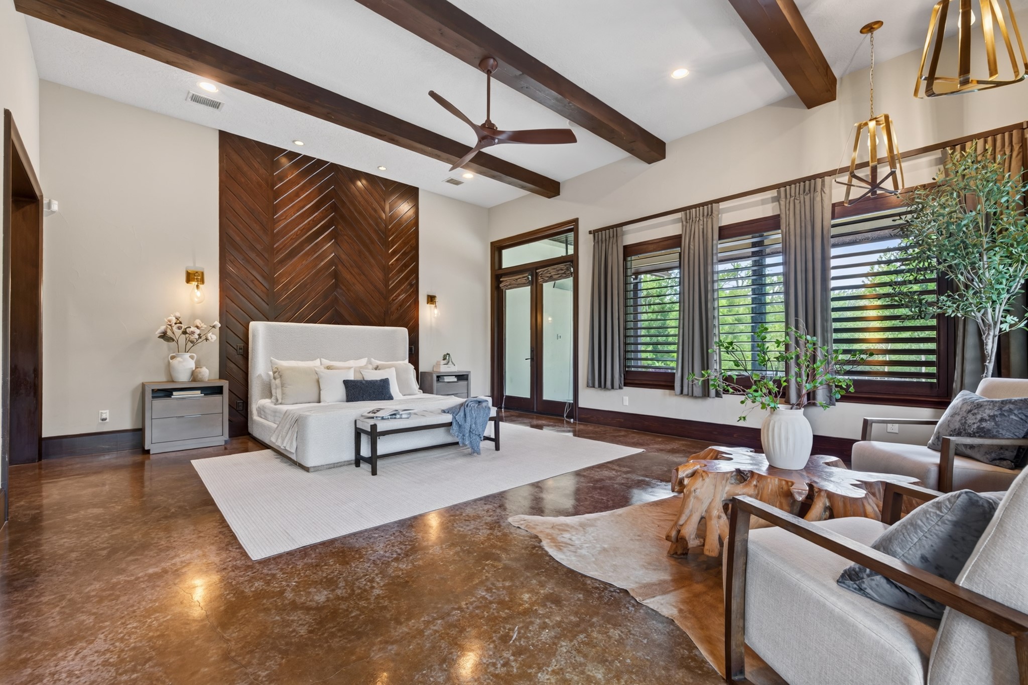 Expansive primary suite measuring approximately 23'  19', with soaring beamed ceilings, abundant natural light and peaceful views of the horses and grounds.