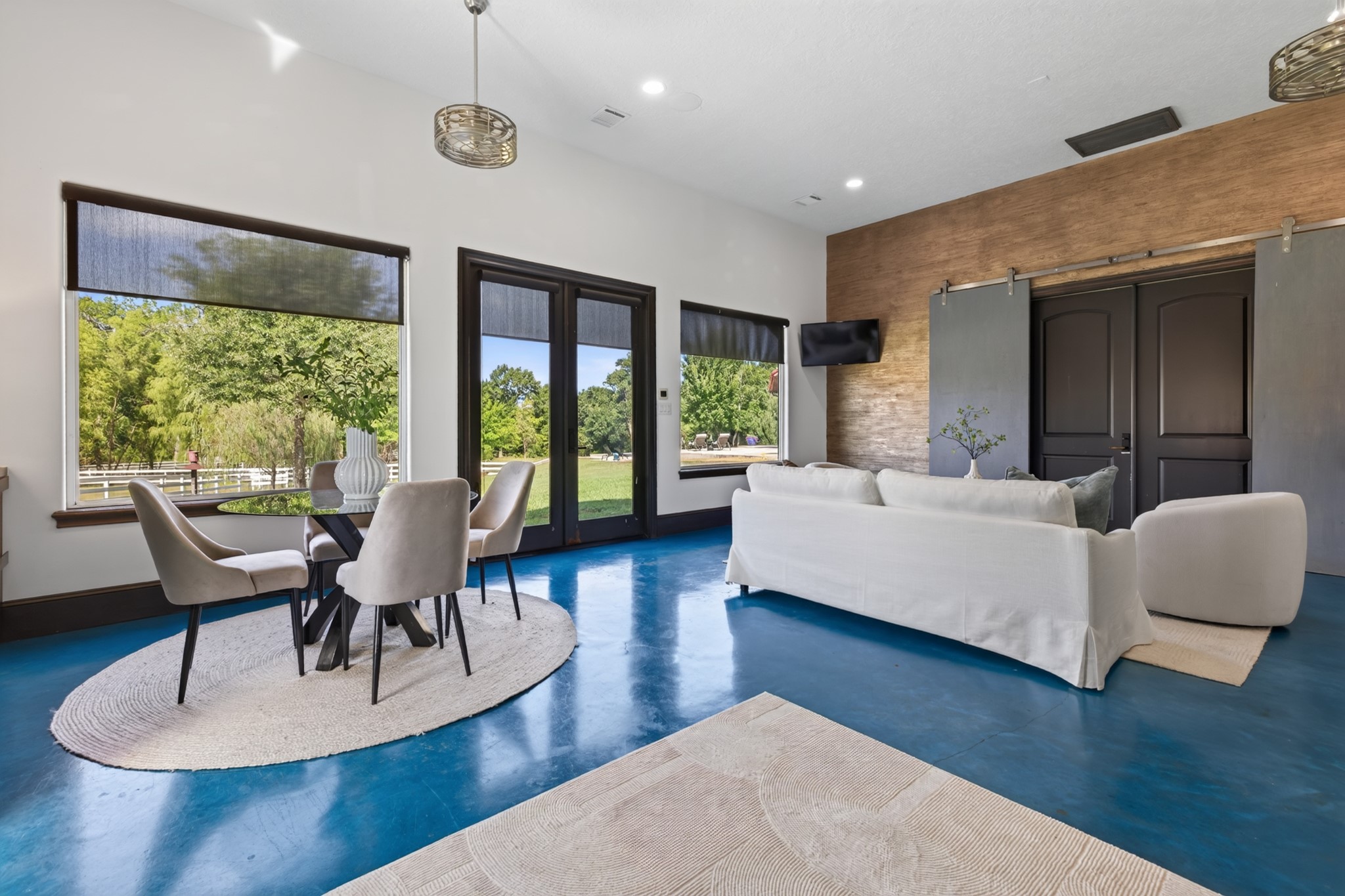 Walls of windows fill the Guest Quarters living room with light and peaceful pastoral views.