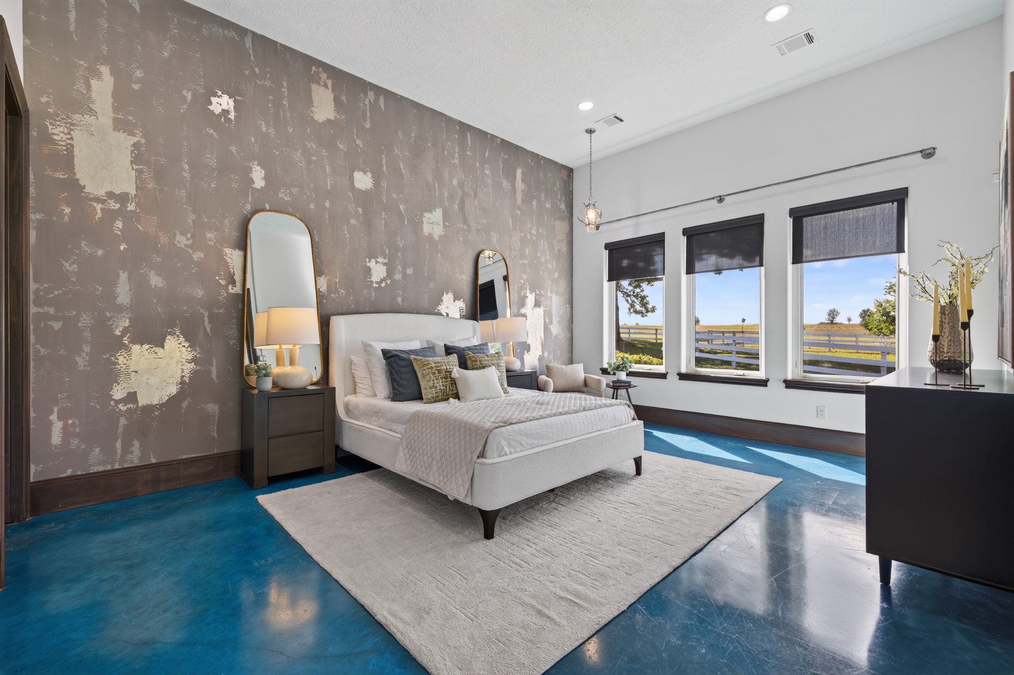 High ceilings and signature blue floors make the Guest Quarters bedroom feel wonderfully distinctive.