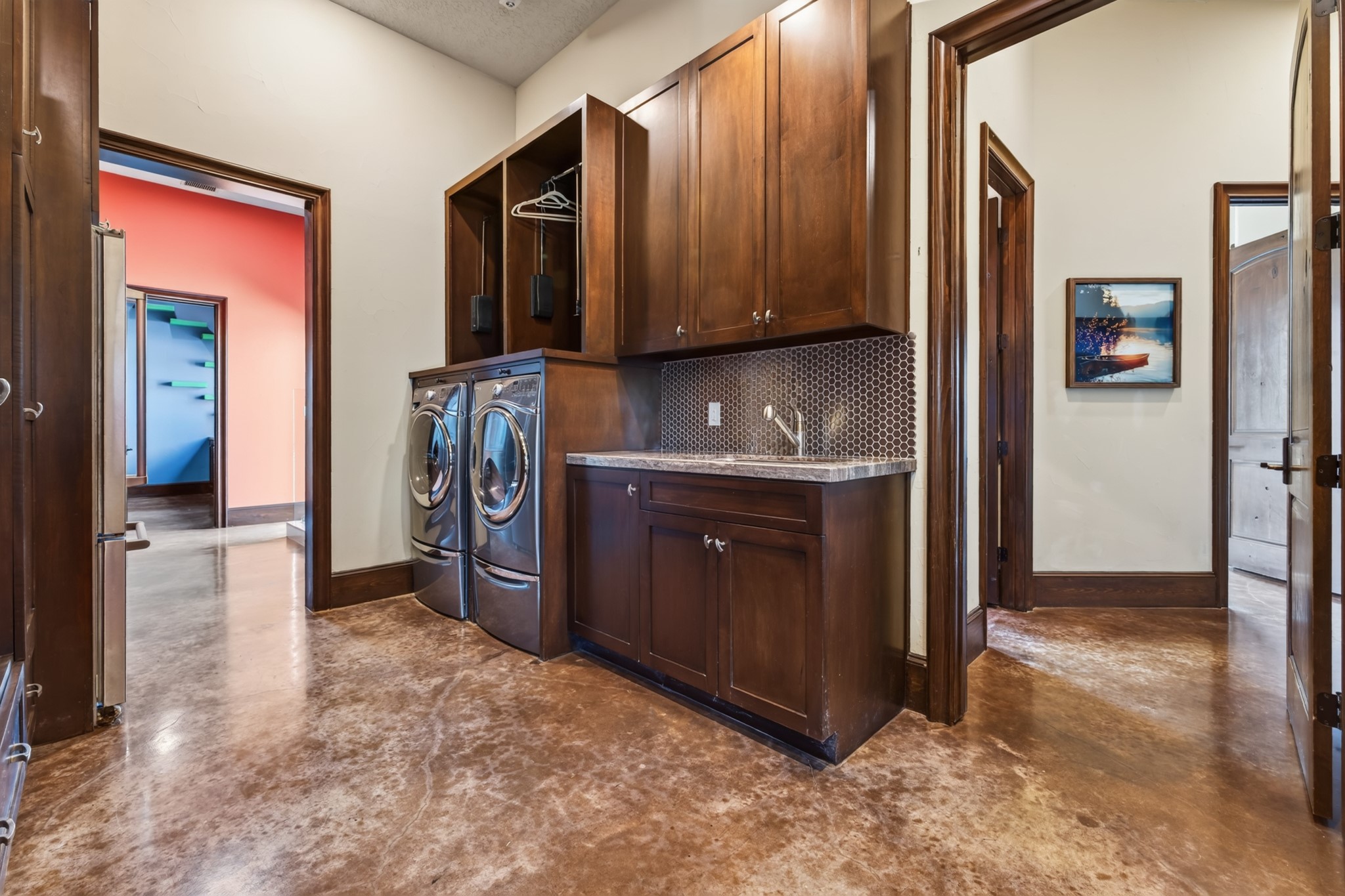 An unusually spacious laundry room brings exceptional storage and ease to everyday country living.