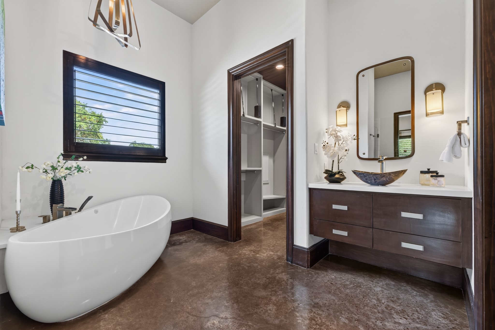 A freestanding soaking tub transforms the primary bath into a calm, restorative retreat.