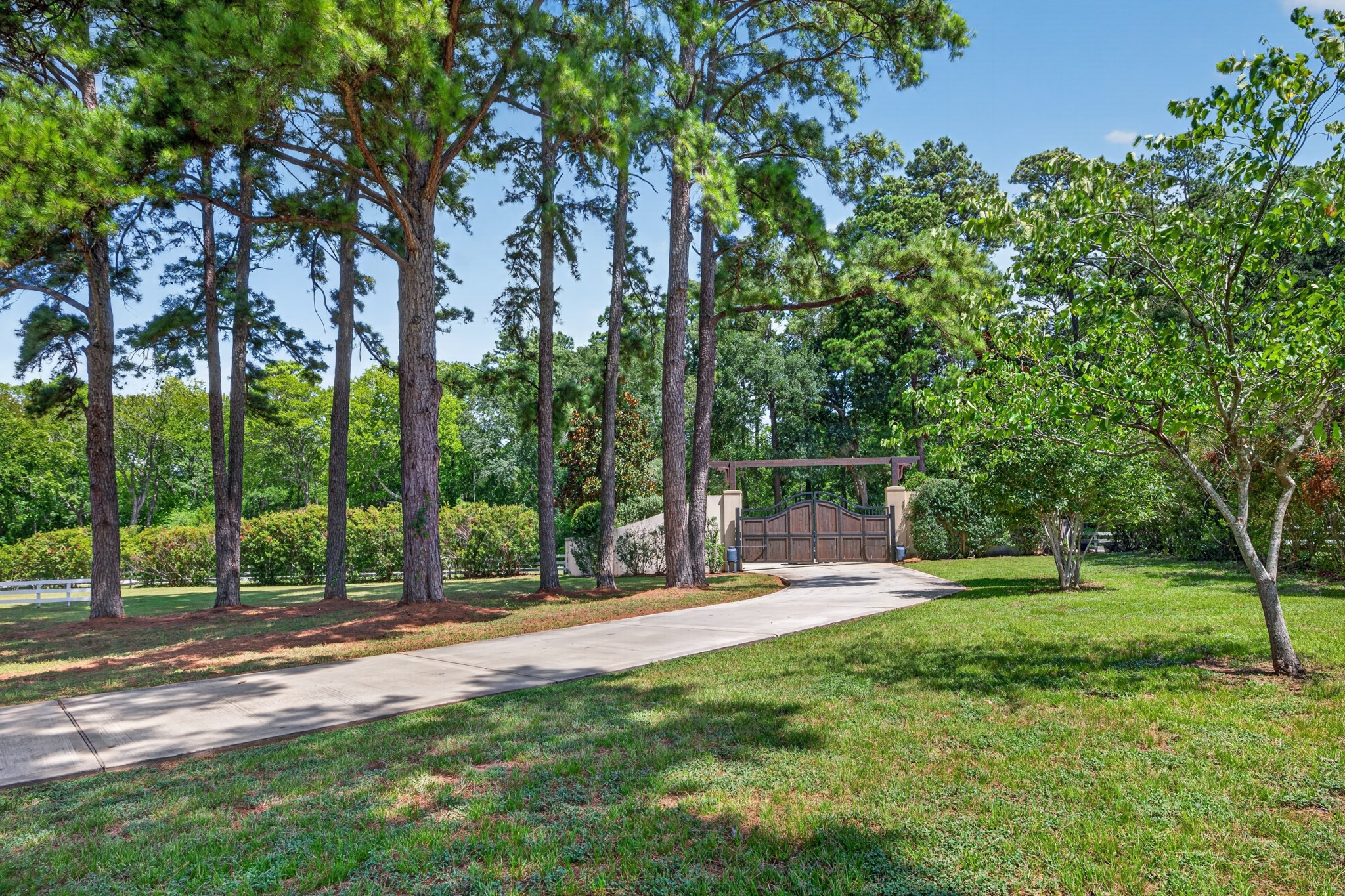 A long, tree-lined drive slowly reveals the home and leaves the outside world behind.