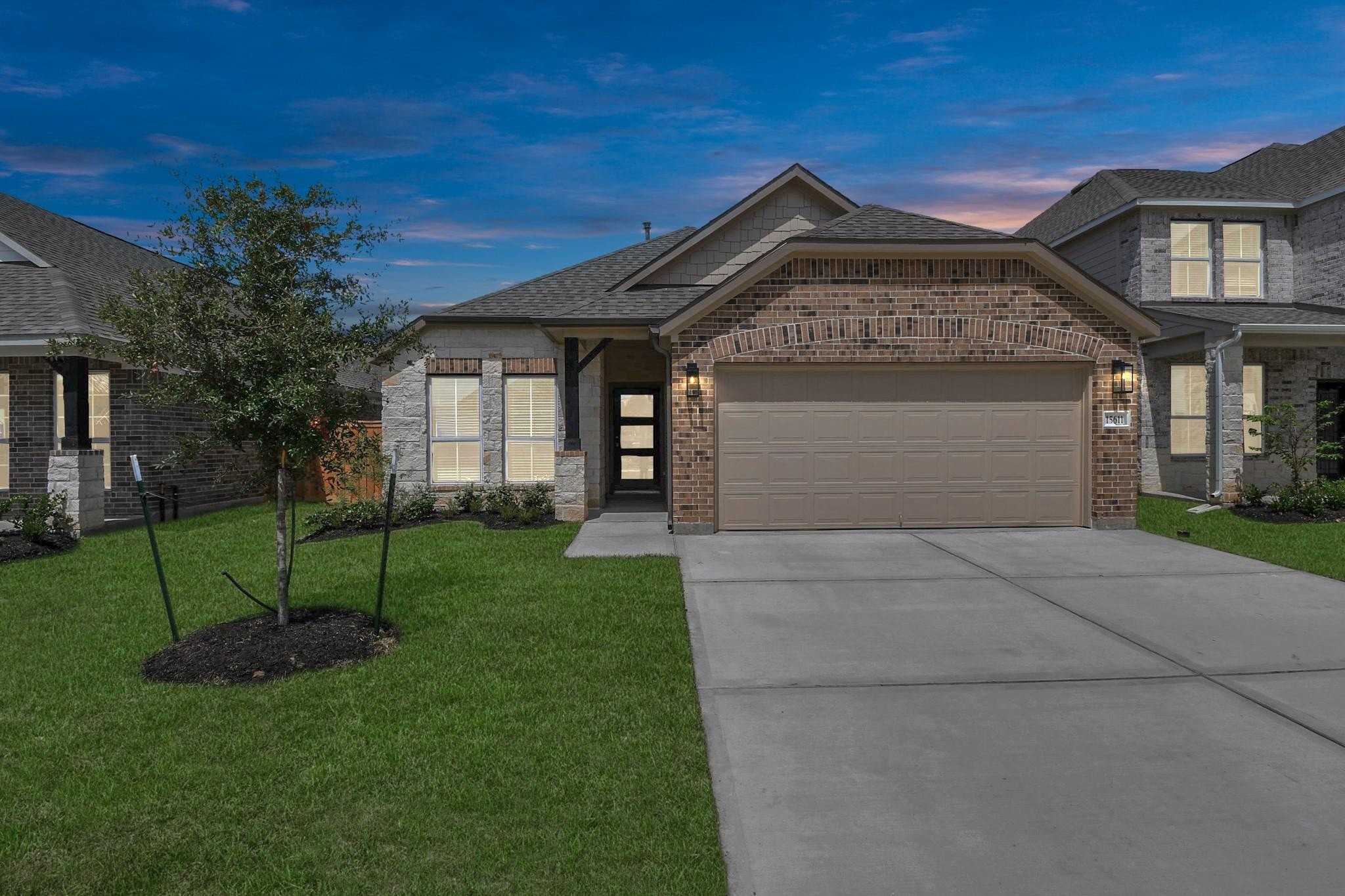Home offers 2 car garage and modern style glass leaded front door. Home offers 2 car garage and modern style glass leaded front door.