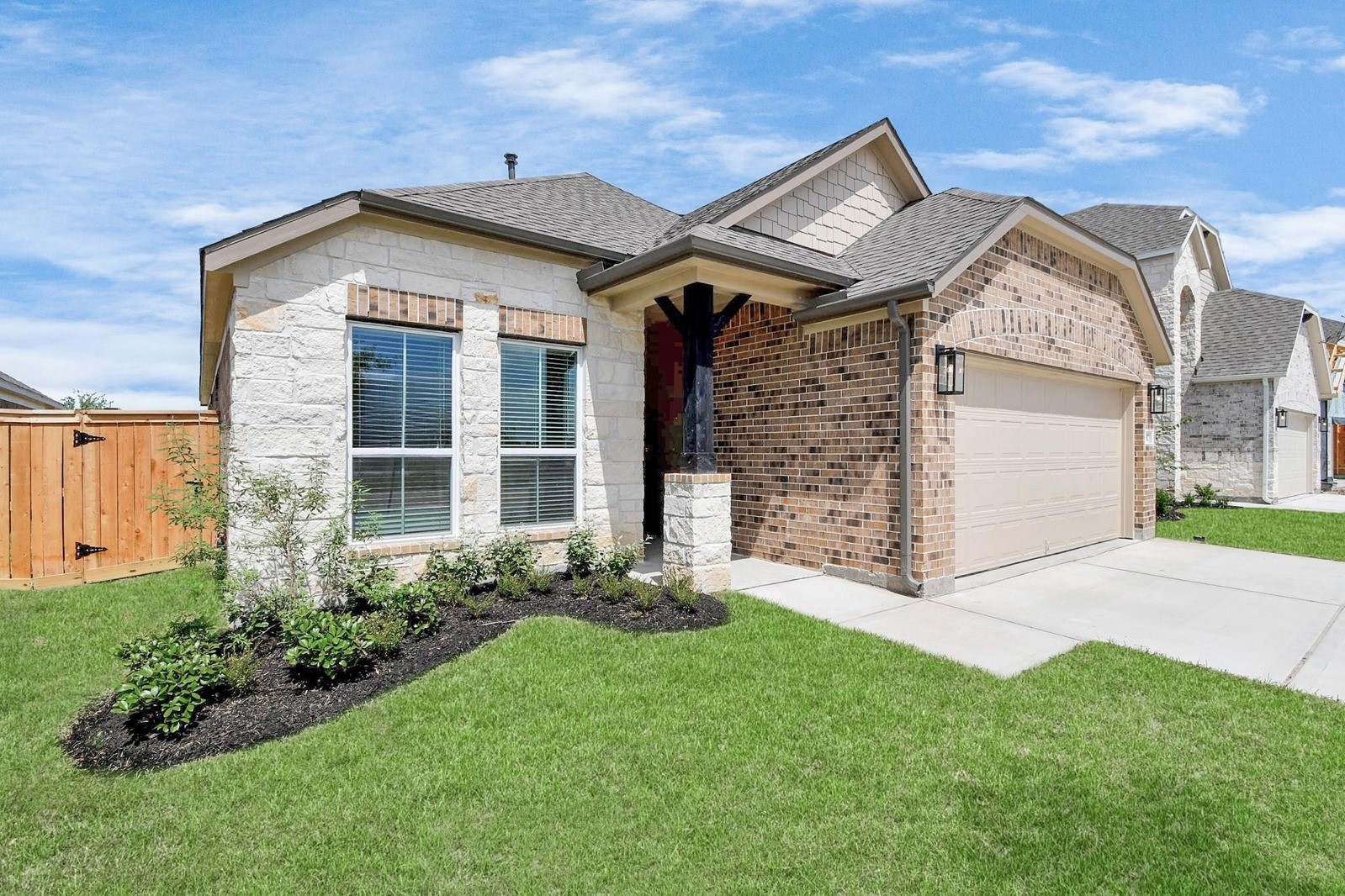 This home features an elegant front elevation with a charming blend of brick and stone accents, complemented by a well-manicured lawn and inviting entryway. This home features an elegant front elevation with a charming blend of brick and stone accents, complemented by a well-manicured lawn and inviting entryway.