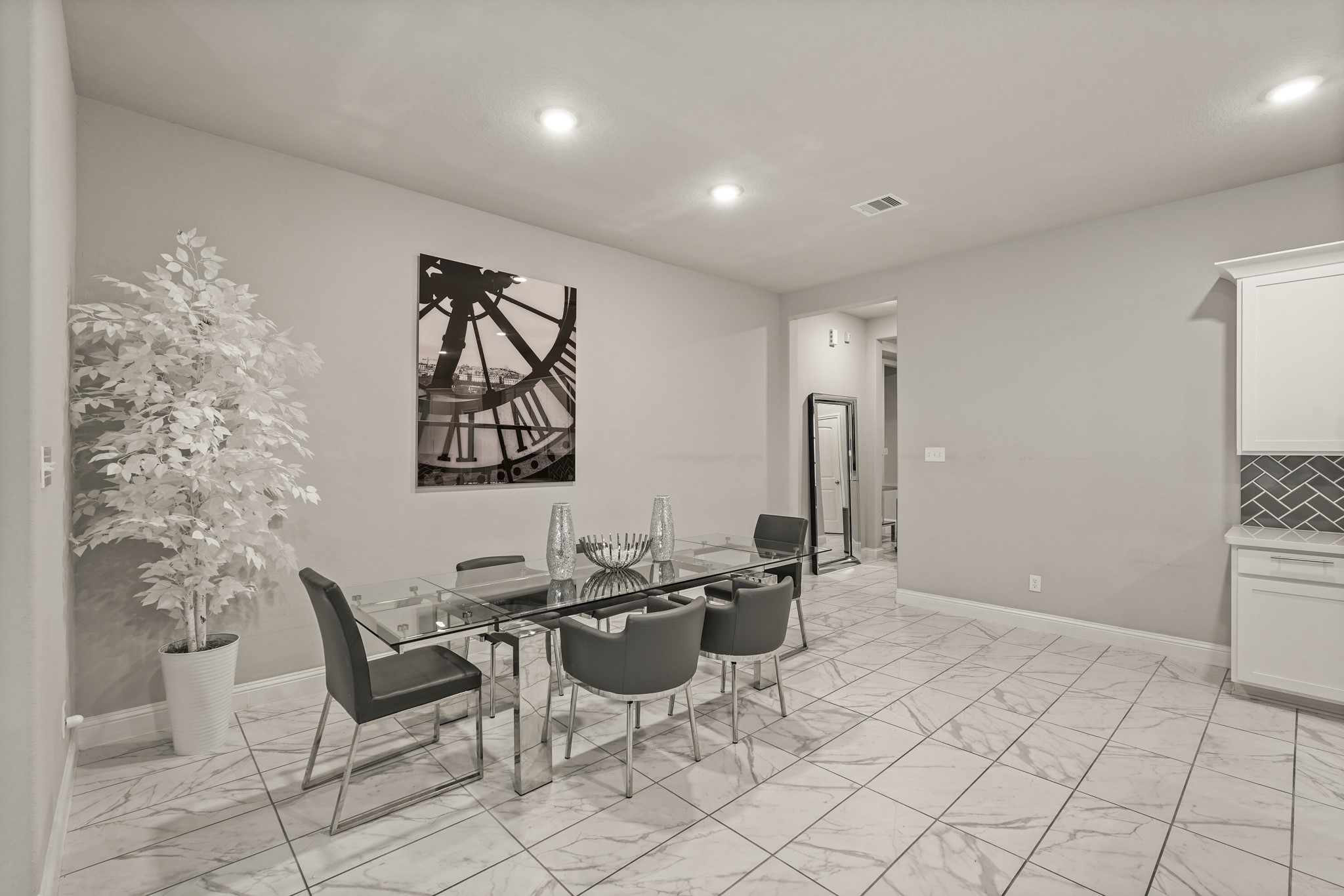 A look at the dedicated dining zone, emphasizing the home's spacious and interconnected floor plan. The area is highlighted by its clean lines, and bright overhead lighting. Sitting adjacent to the kitchen workspace, this versatile room offers plenty of layout flexibility for family meals
while remaining open to the rest of the main floor. A look at the dedicated dining zone, emphasizing the home's spacious and interconnected floor plan. The area is highlighted by its clean lines, and bright overhead lighting. Sitting adjacent to the kitchen workspace, this versatile room offers plenty of layout flexibility for family meals
while remaining open to the rest of the main floor.