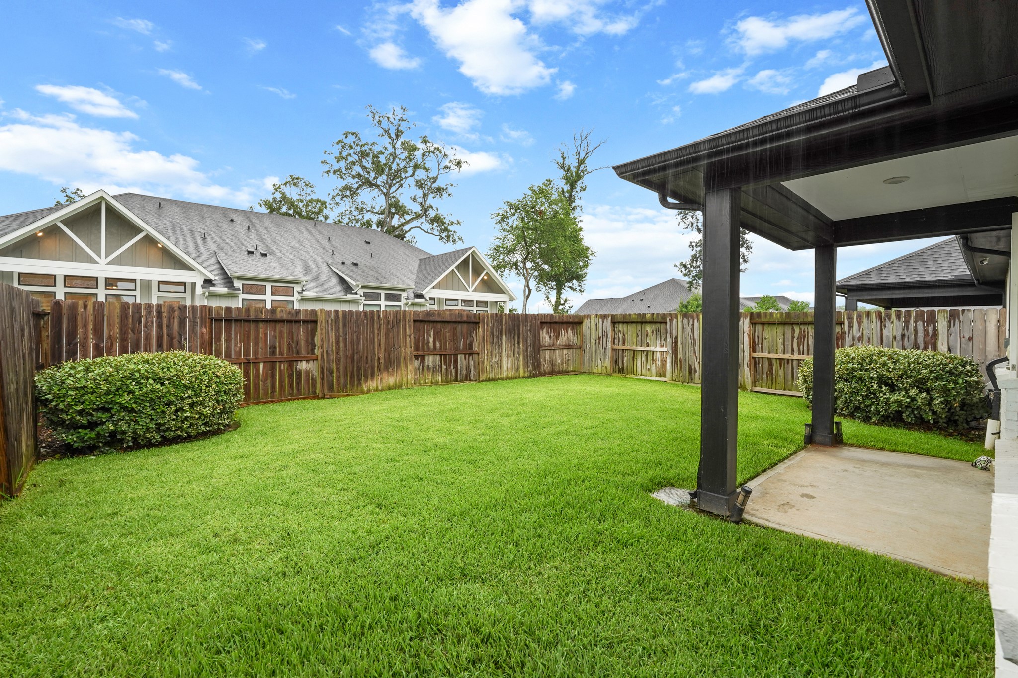This backyard offers a secure and private setting for relaxing or entertaining. The clean layout makes it an inviting, low-maintenance outdoor area.