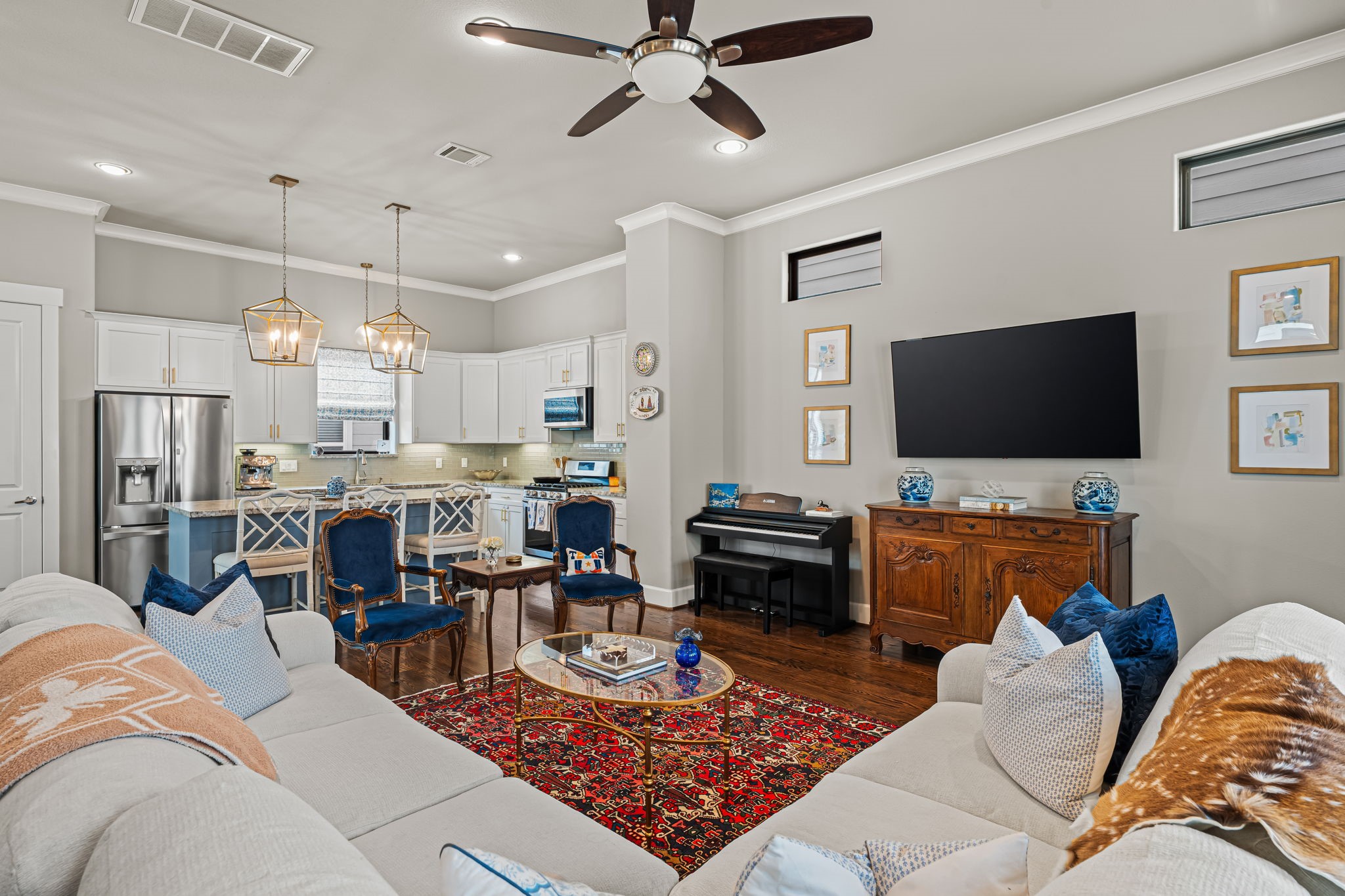 Generous proportions make the living area a comfortable place to gather. Its open connection to the kitchen keeps refreshments, conversation, and company within easy reach.