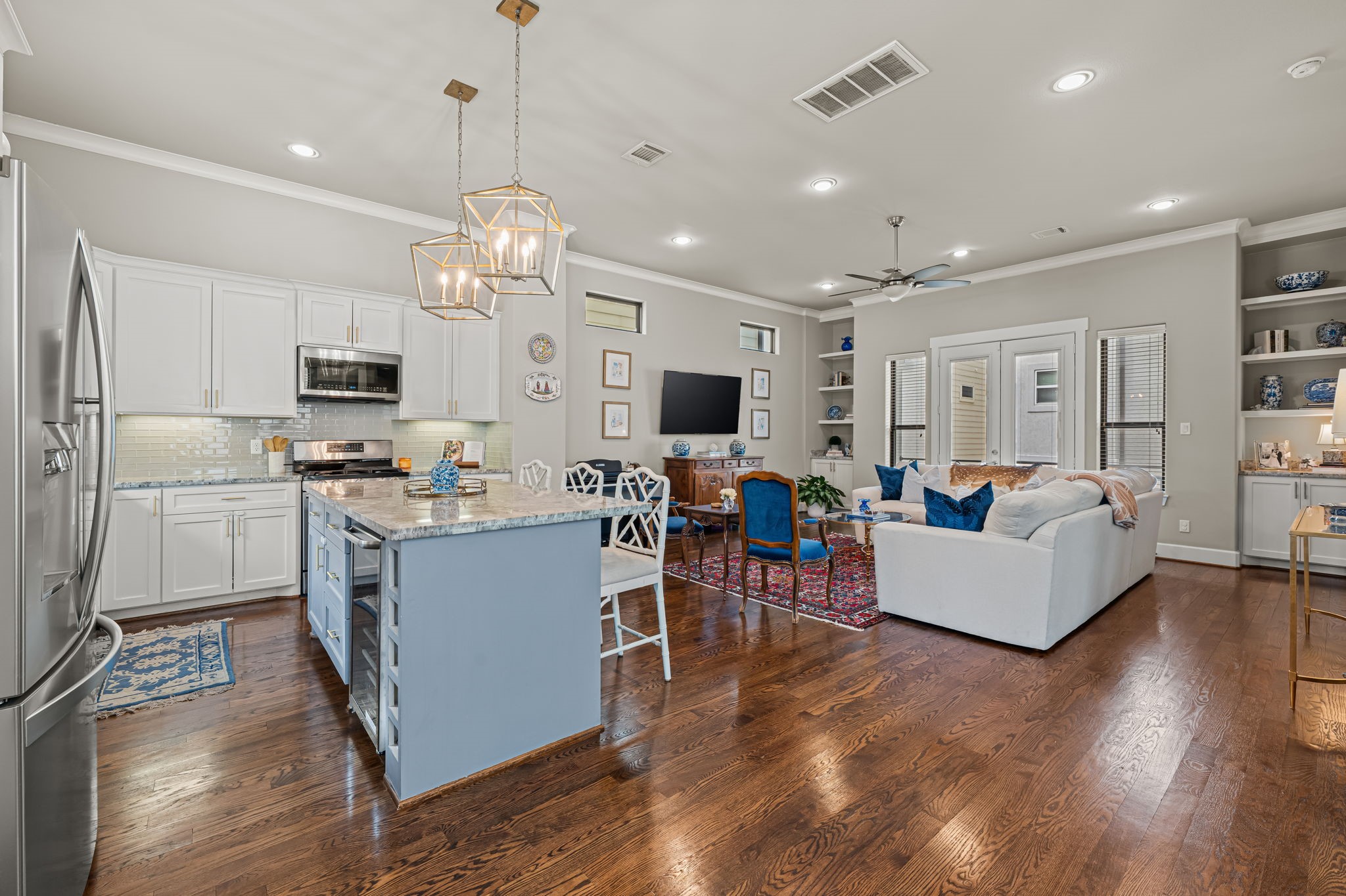An open kitchen keeps the cook at the heart of the conversation. Expansive counters and an island work surface offer room to prepare, serve, and linger together.