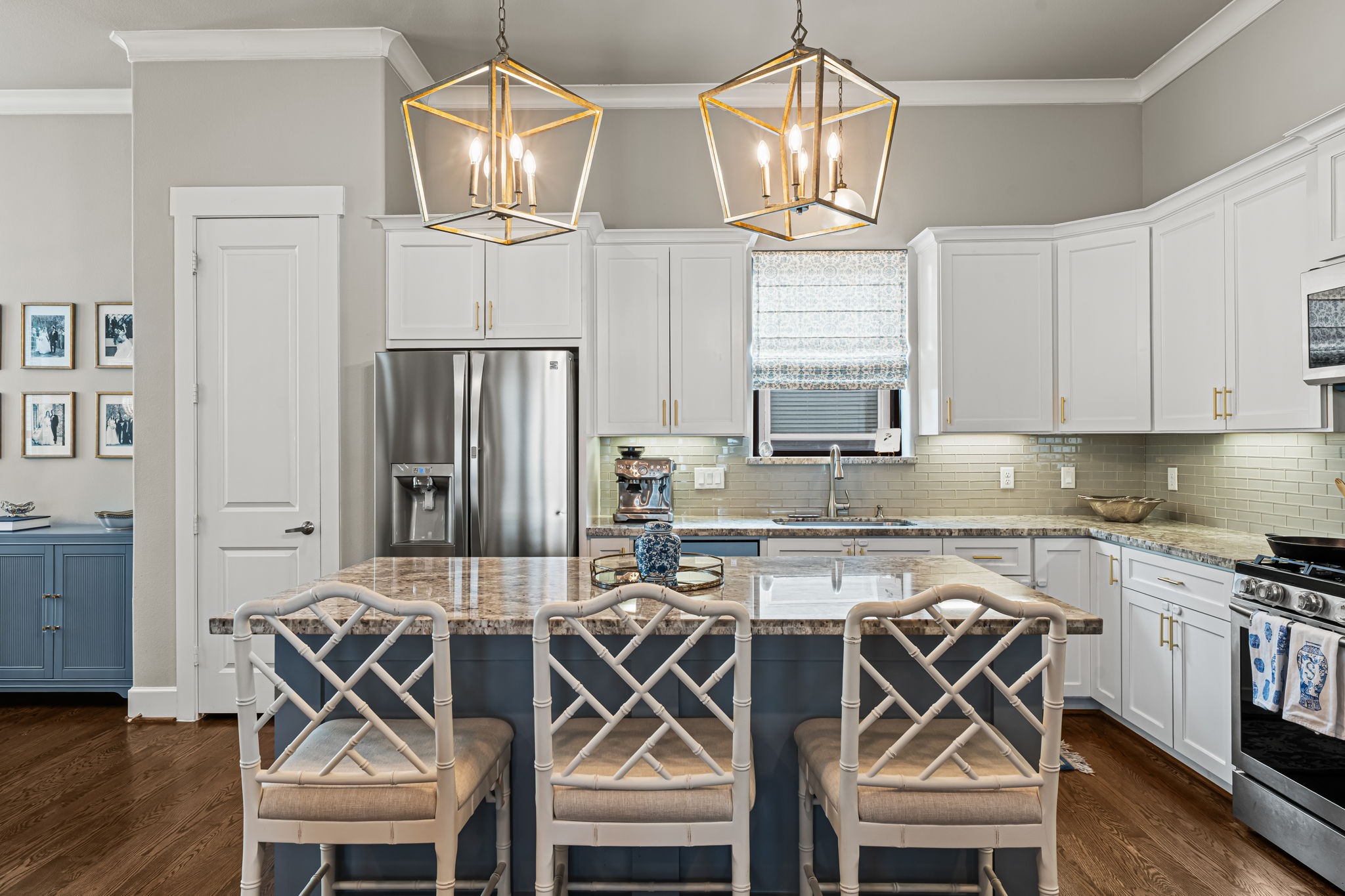 Lantern pendants cast a warm glow over the island, while a window above the sink brightens the kitchen. Lantern pendants cast a warm glow over the island, while a window above the sink brightens the kitchen.