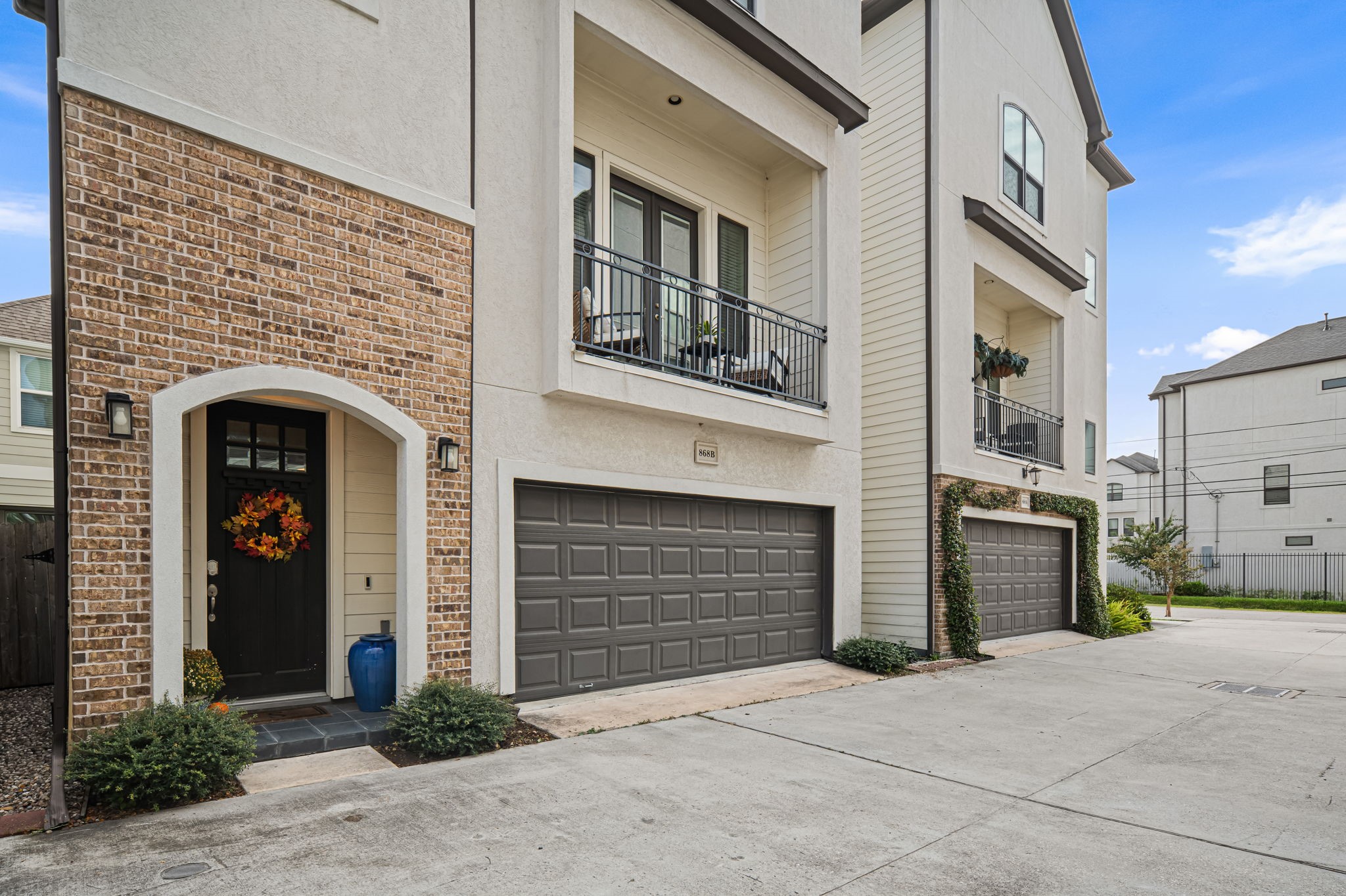 Warm brick frame a gracious arrival, with a sheltered entry beside the attached two-car garage. The facade's arched details echo the home's traditional character.