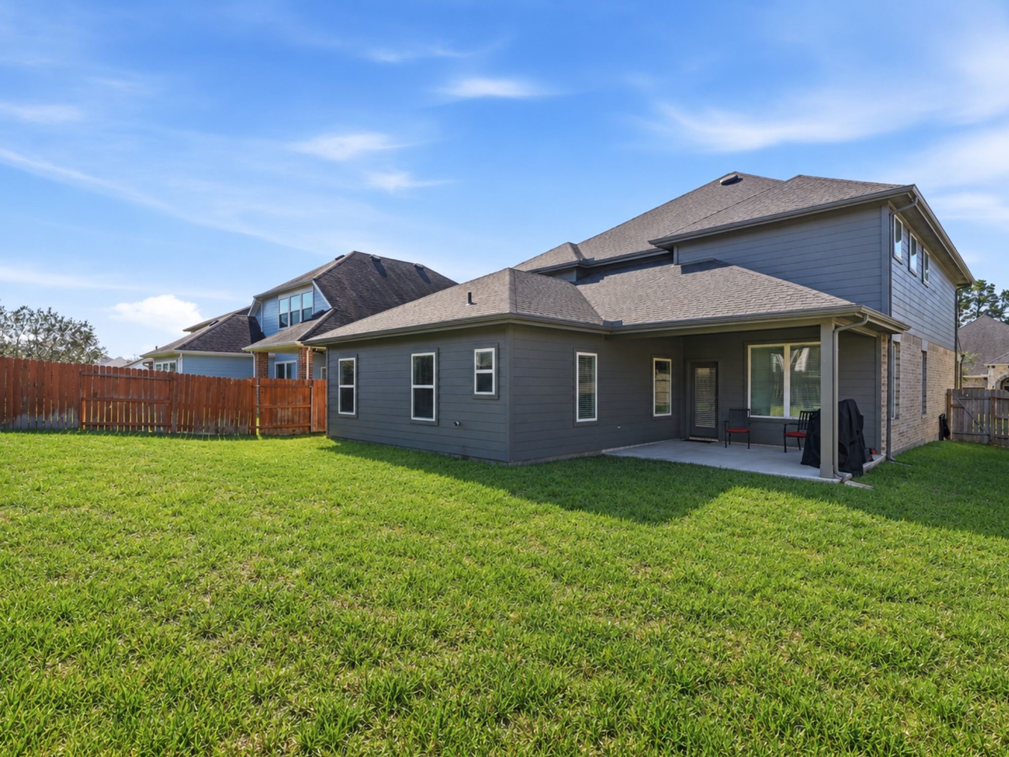 Backyard is perfect for play. Notice the covered back patio.