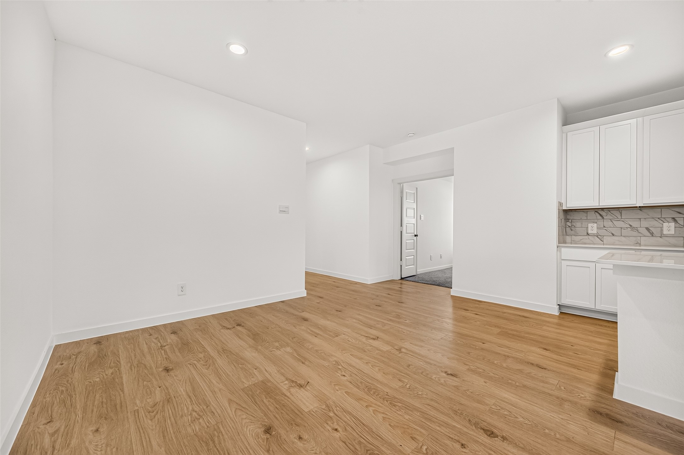 The dining room sits in the kitchen area to the side and opens to family room as well.