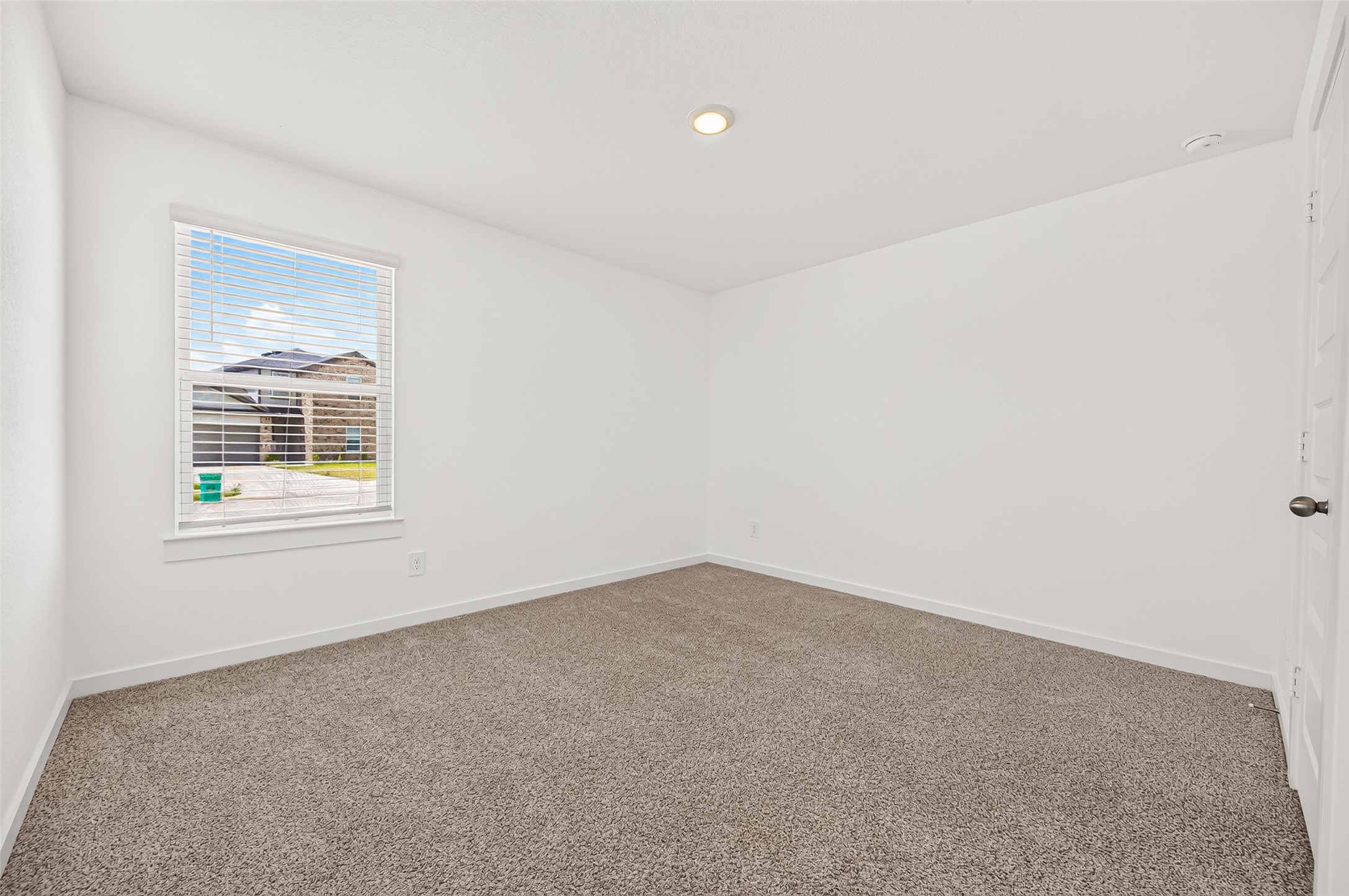 The first guest bedroom sits in the front of the home.