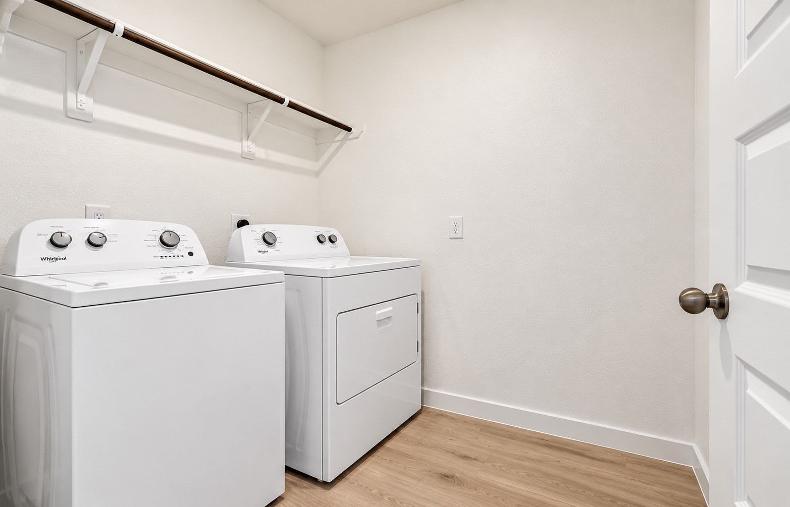 Laundry room, washer/ dryer and shelving.