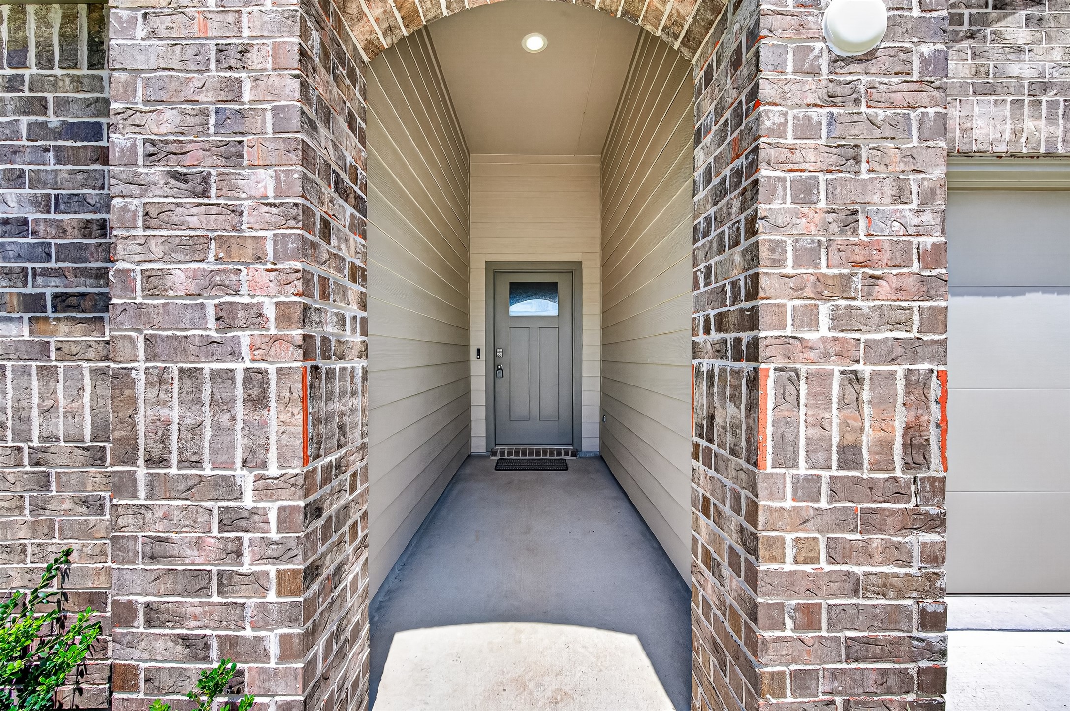 Covered porch entryway. Video doorbell.