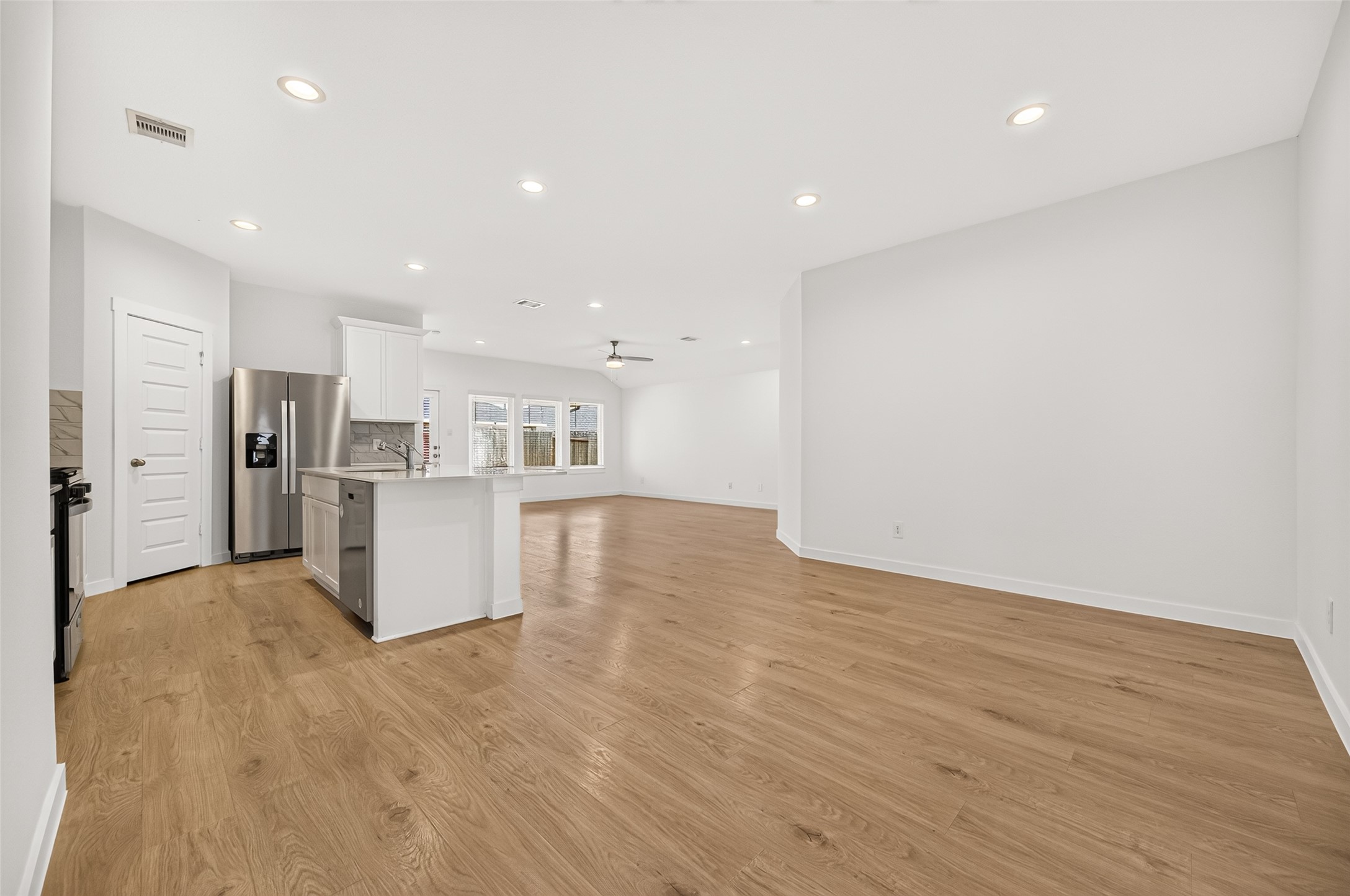 As you walk into the home past the hallways and guest bedrooms, the kitchen, dining room and family room greet you.